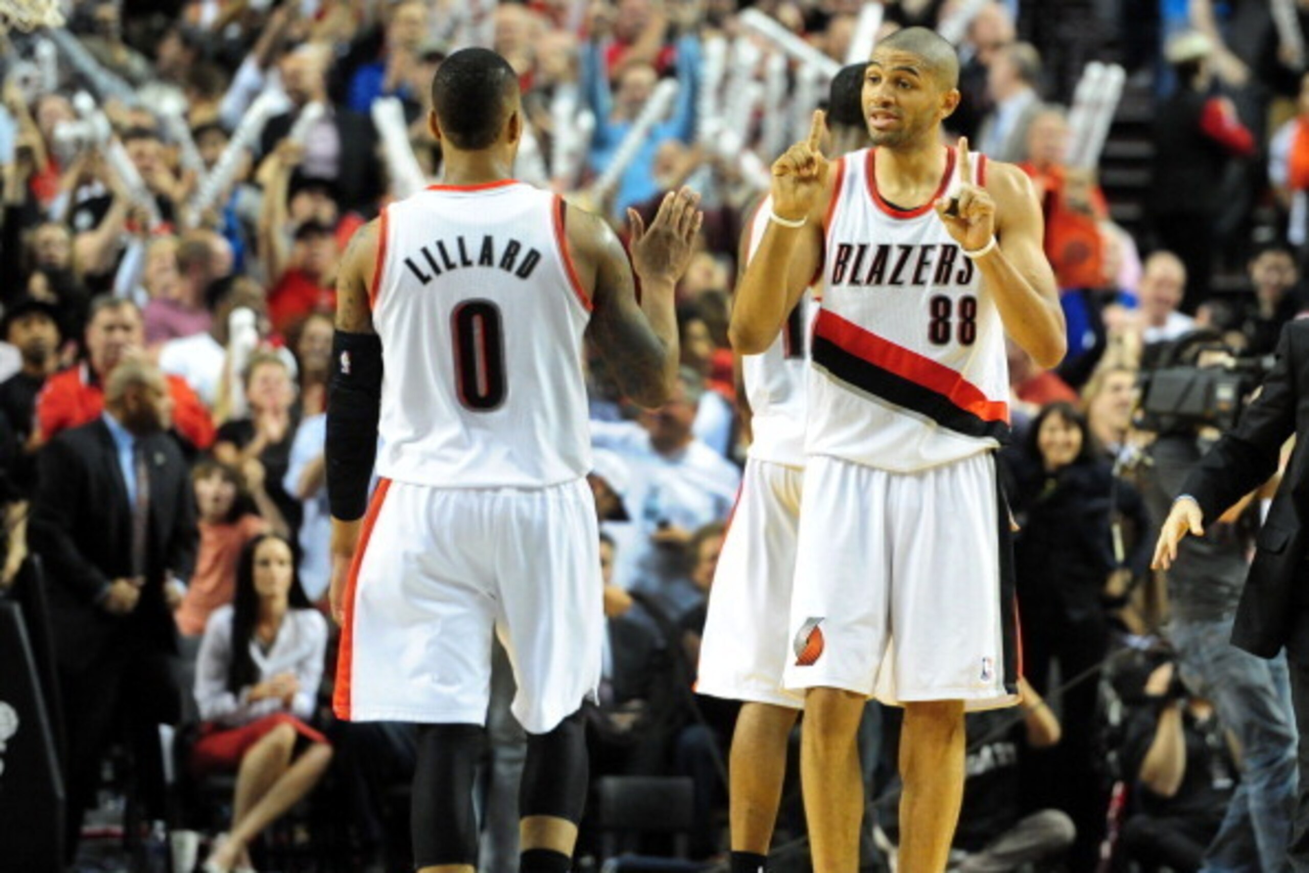 PORTLAND, OR - APRIL  27: Damian Lillard #0 of the Portland Trail Blazers and Nicolas Batum #88 of the Portland Trail Blazers celebrate in the second half of Game Four of the Western Conference Quarterfinals against the Houston Rockets during the 2014 NBA