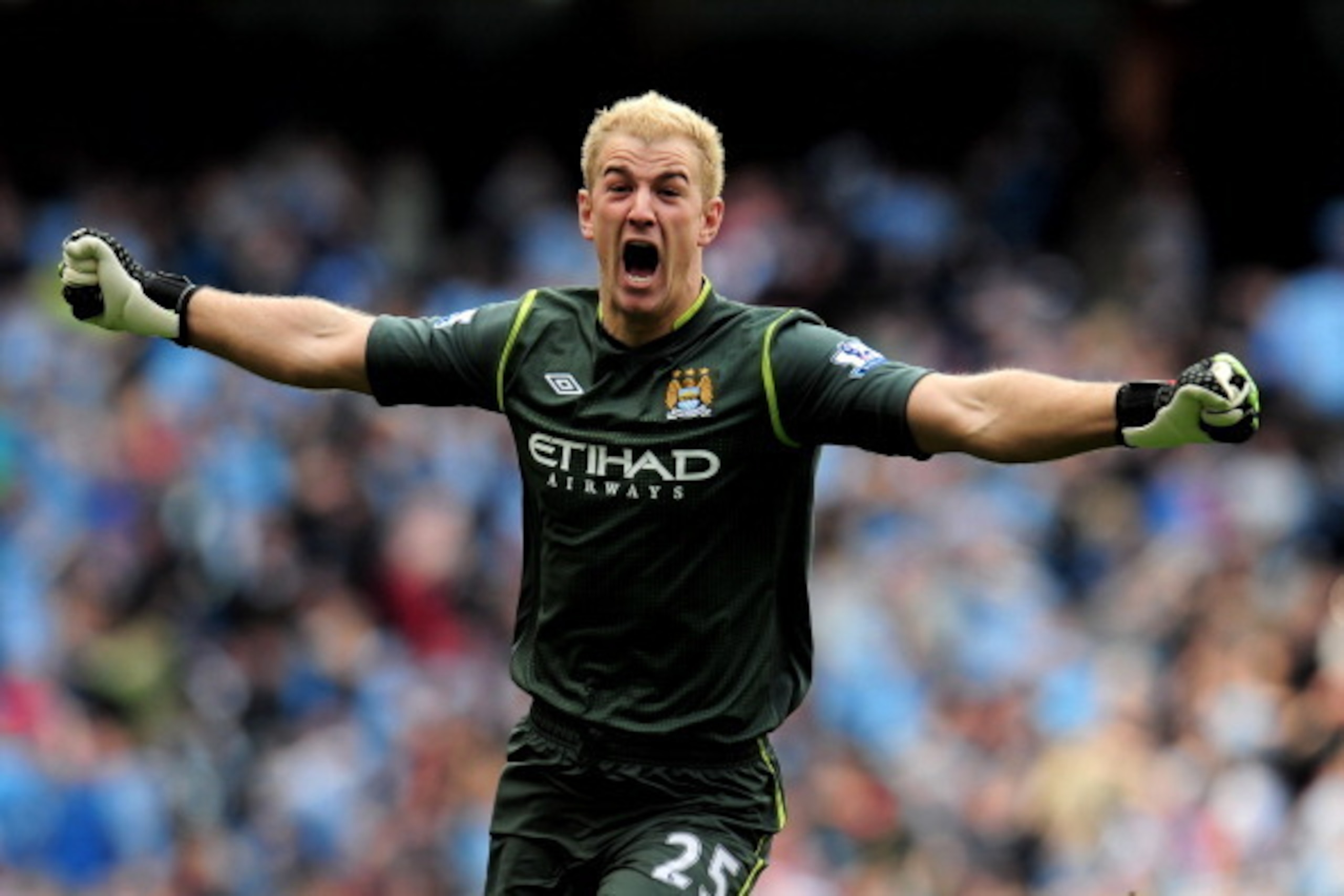 MANCHESTER, ENGLAND - MAY 13:  Goalkeeper Joe Hart of Manchester City celebrates winning the title as the final whistle blows during the Barclays Premier League match between Manchester City and Queens Park Rangers at the Etihad Stadium on May 13, 2012 in