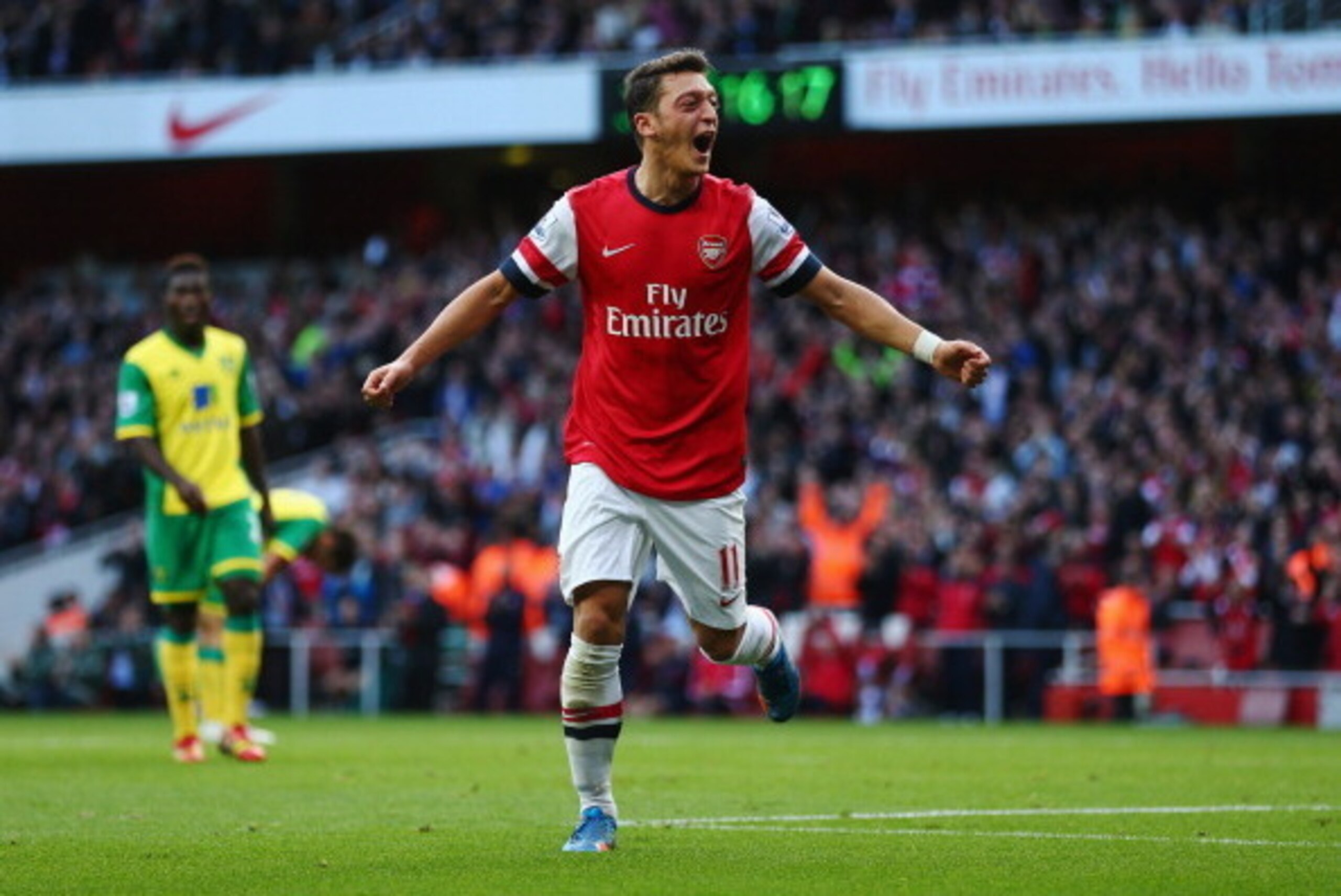 LONDON, ENGLAND - OCTOBER 19:  Mesut Oezil of Arsenal celebrates as he scores their second goal during the Barclays Premier League match between Arsenal and Norwich City at Emirates Stadium on October 19, 2013 in London, England.  (Photo by Paul Gilham/Ge