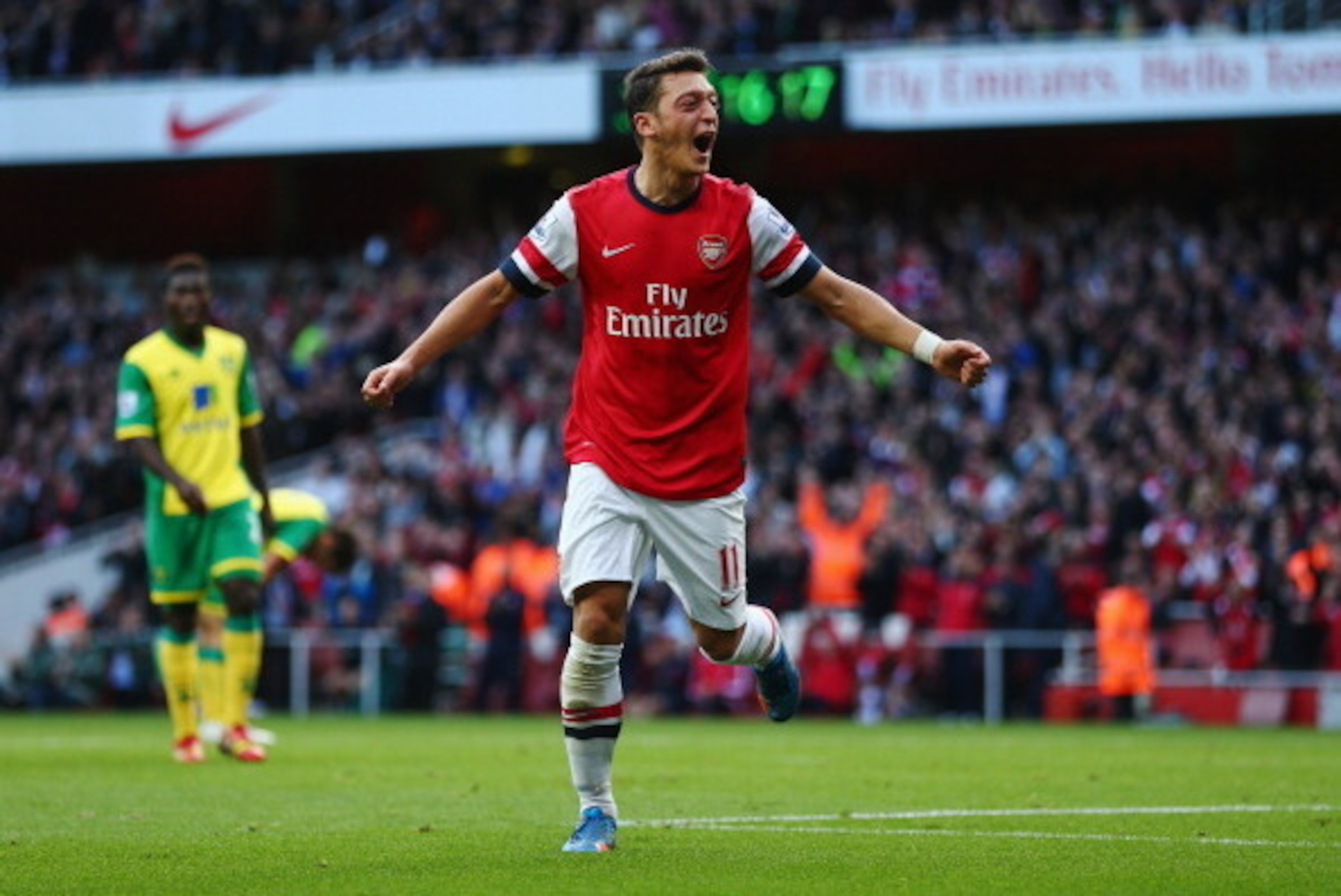 LONDON, ENGLAND - OCTOBER 19:  Mesut Oezil of Arsenal celebrates as he scores their second goal during the Barclays Premier League match between Arsenal and Norwich City at Emirates Stadium on October 19, 2013 in London, England.  (Photo by Paul Gilham/Ge