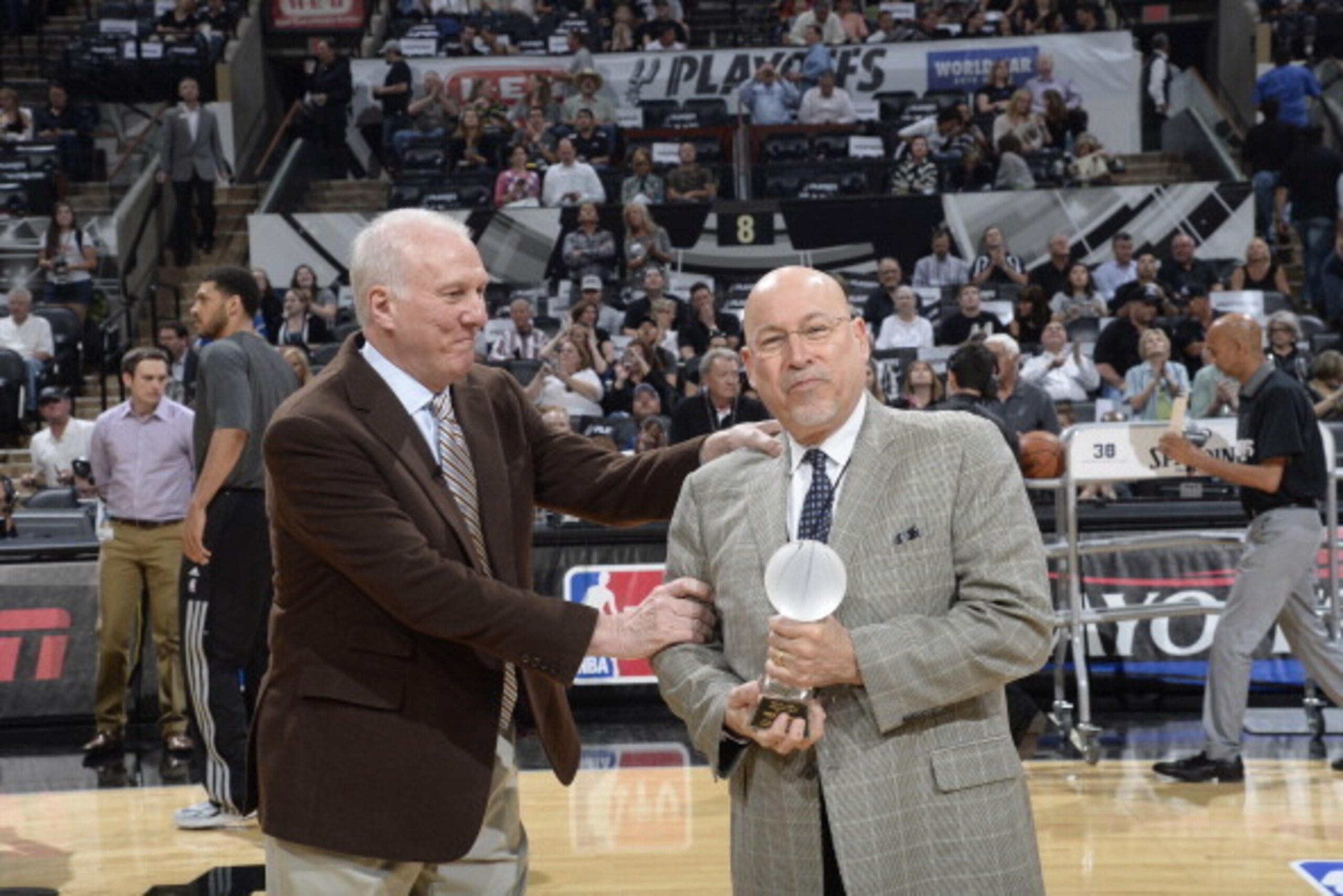 SAN ANTONIO, TX - April 30: Gregg Popovich gives Mike Monroe of Express News, the Phil Jasner Lifetime Achievement Award by the Professional Basketball Writers Association before Game Five of the Western Conference Quarterfinals between the Dallas Maveric