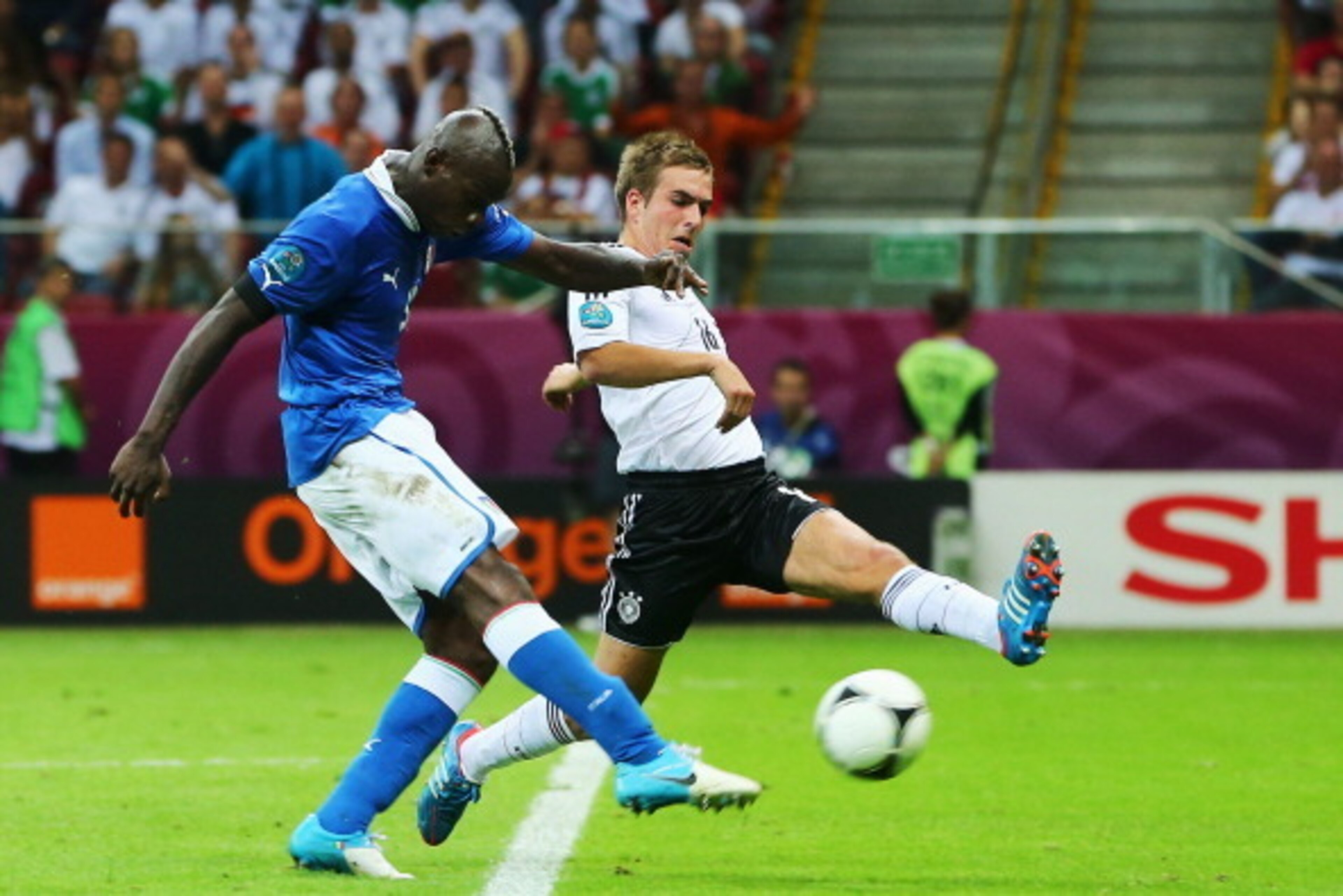 WARSAW, POLAND - JUNE 28: Mario Balotelli of Italy scores his team's second goal past Philipp Lahm of Germany during the UEFA EURO 2012 semi final match between Germany and Italy at the National Stadium on June 28, 2012 in Warsaw, Poland. (Photo by Alex WARSAW, POLAND - JUNE 28: Mario Balotelli of Italy scores his team's second goal past Philipp Lahm of Germany during the UEFA EURO 2012 semi final match between Germany and Italy at the National Stadium on June 28, 2012 in Warsaw, Poland. (Photo by Alex