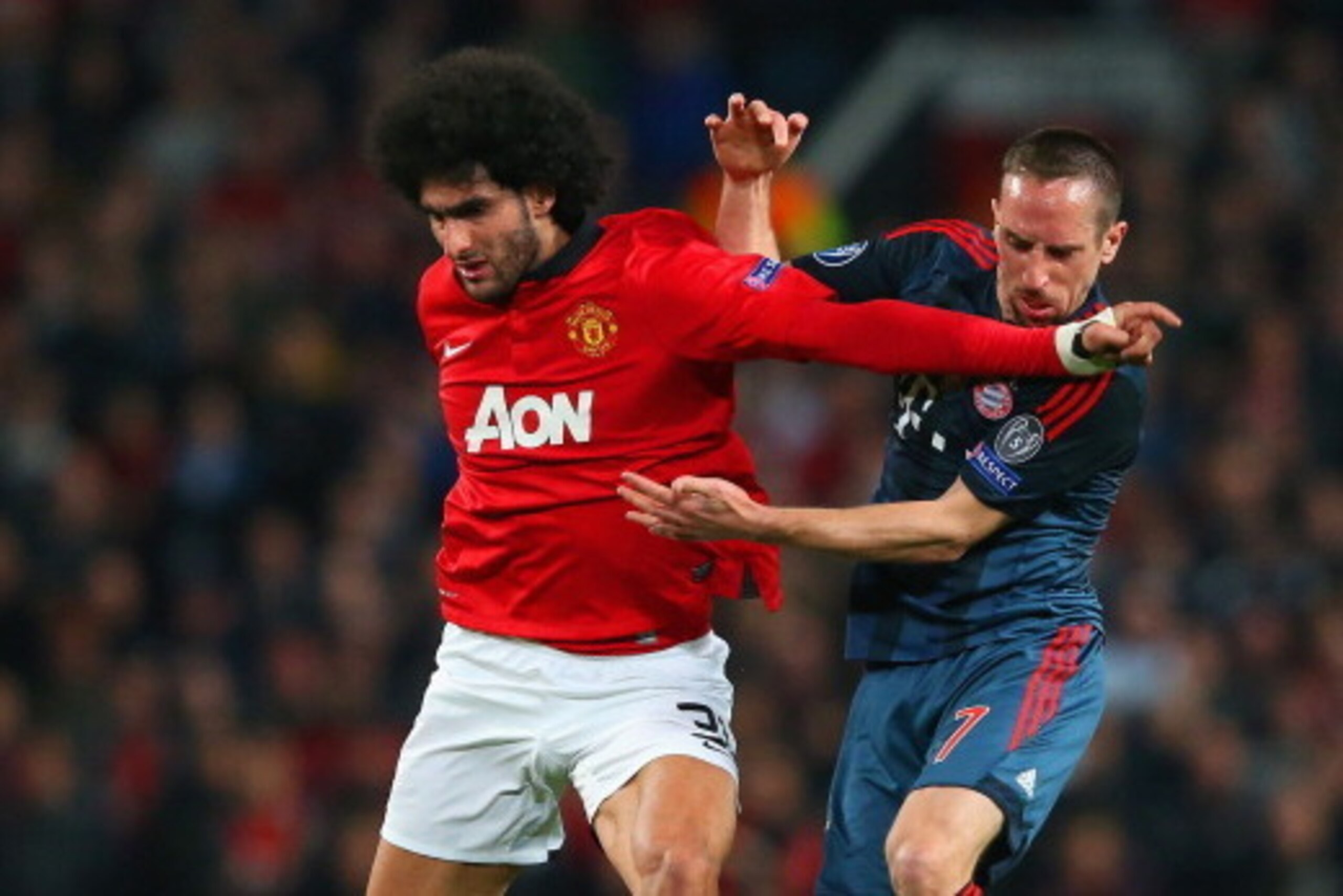 MANCHESTER, ENGLAND - APRIL 01: Marouane Fellaini of Manchester United and Franck Ribery of Bayern Muenchen battle for the ball during the UEFA Champions League Quarter Final first leg match between Manchester United and FC Bayern Muenchen at Old Trafford