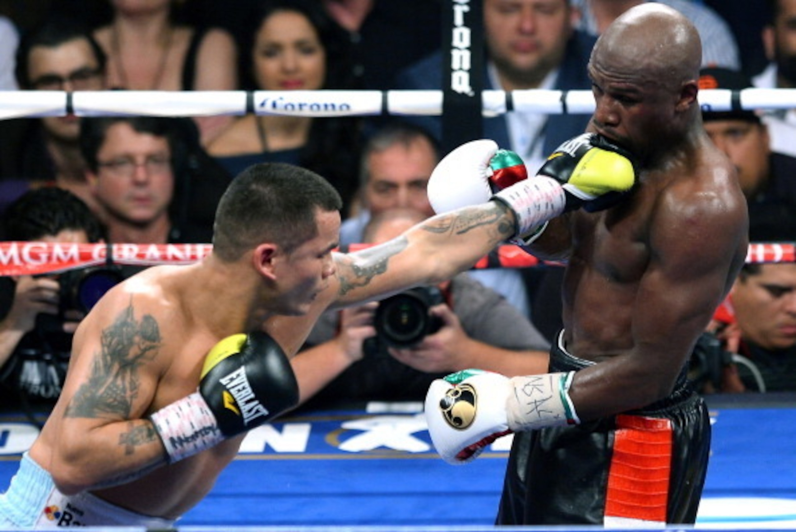 LAS VEGAS, NV - MAY 03: Marcos Maidana (L) throws a left at Floyd Mayweather Jr. in the eighth round of their WBC/WBA welterweight unification fight at the MGM Grand Garden Arena on May 3, 2014 in Las Vegas, Nevada. Mayweather took Maidana's title with a LAS VEGAS, NV - MAY 03: Marcos Maidana (L) throws a left at Floyd Mayweather Jr. in the eighth round of their WBC/WBA welterweight unification fight at the MGM Grand Garden Arena on May 3, 2014 in Las Vegas, Nevada. Mayweather took Maidana's title with a