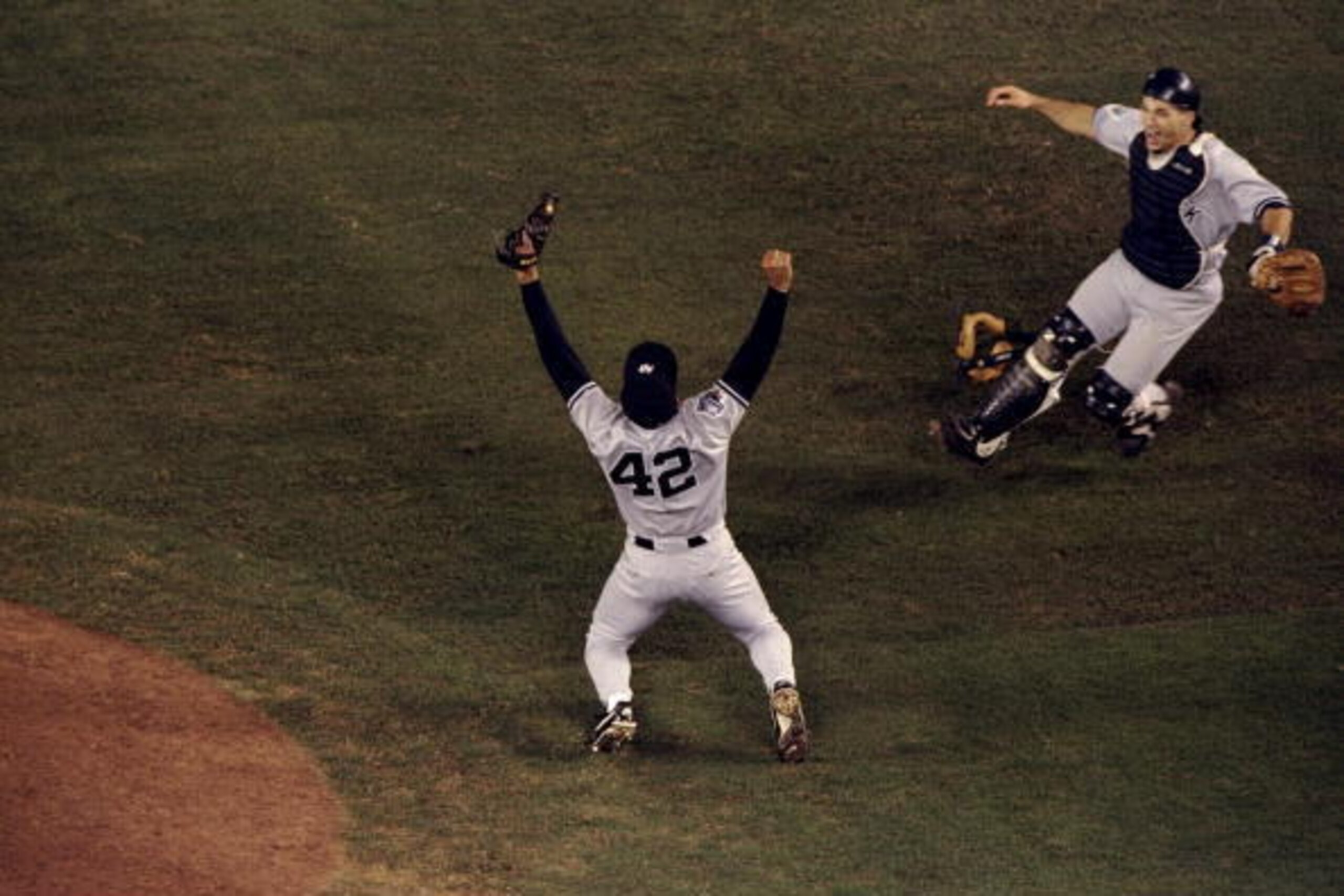 21 Oct 1998: Pitcher Mariano Rivera #42 and catcher Joe Girardi #25 of the New York Yankees celebrate following the 1998 World Series Game 4 against the San Diego Padres at Qualcomm Stadium in San Diego, California. The Yankees defeated the Padres 3-0.
