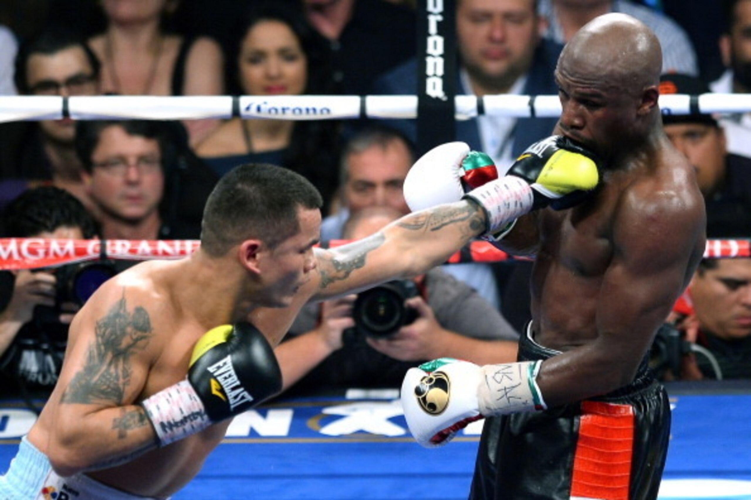 LAS VEGAS, NV - MAY 03:  Marcos Maidana (L) throws a left at Floyd Mayweather Jr. in the eighth round of their WBC/WBA welterweight unification fight at the MGM Grand Garden Arena on May 3, 2014 in Las Vegas, Nevada. Mayweather took Maidana's title with a
