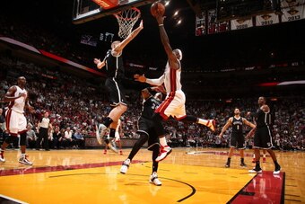 MIAMI, FL - APRIL 8:   Mason Plumlee #1 of the Brooklyn Nets goes up to block the shot of LeBron James #6 of the Miami Heat on April 8, 2014 at American Airlines Arena in Miami, Florida.  NOTE TO USER: User expressly acknowledges and agrees that, by downl