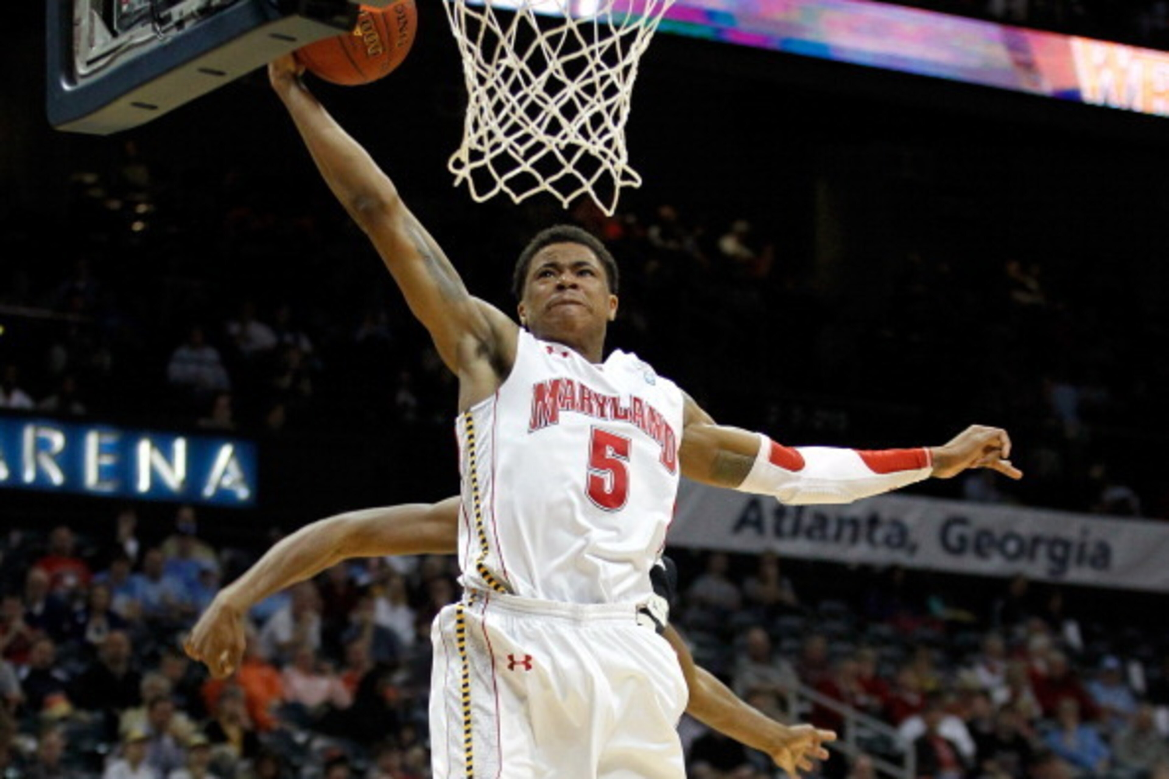 ATLANTA, GA - MARCH 08:  Nick Faust #5 of the Maryland Terrapins drives for a dunk past Travis McKie #30 of the Wake Forest Demon Deacons during their first round game of 2012 ACC Men's Basketball Conferene Tournament at Philips Arena on March 8, 2012 in 