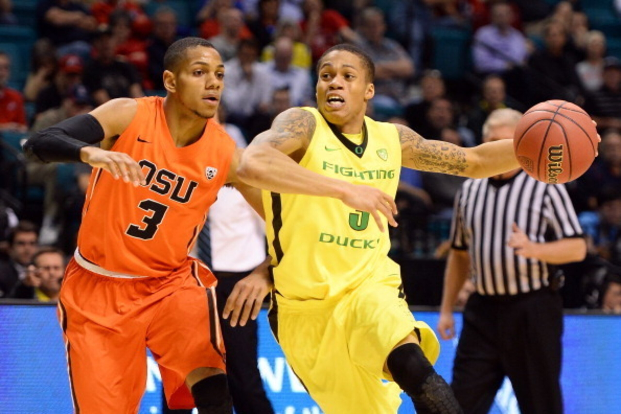 LAS VEGAS, NV - MARCH 12:  Joseph Young #3 of the Oregon Ducks drives against Hallice Cooke #3 of the Oregon State Beavers during a first-round game of the Pac-12 Basketball Tournament at the MGM Grand Garden Arena on March 12, 2014 in Las Vegas, Nevada. 