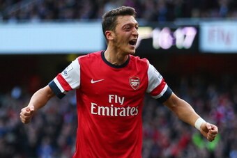 LONDON, ENGLAND - OCTOBER 19:  Mesut Oezil of Arsenal celebrates as he scores their second goal during the Barclays Premier League match between Arsenal and Norwich City at Emirates Stadium on October 19, 2013 in London, England.  (Photo by Paul Gilham/Ge