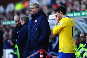 STOKE ON TRENT, ENGLAND - MARCH 01:  Arsene Wenger of Arsenal bring on substitute Mesut Ozil during the Barclays Premier League match between Stoke City and Arsenal at Britannia Stadium on March 1, 2014 in Stoke on Trent, England.  (Photo by Laurence Grif