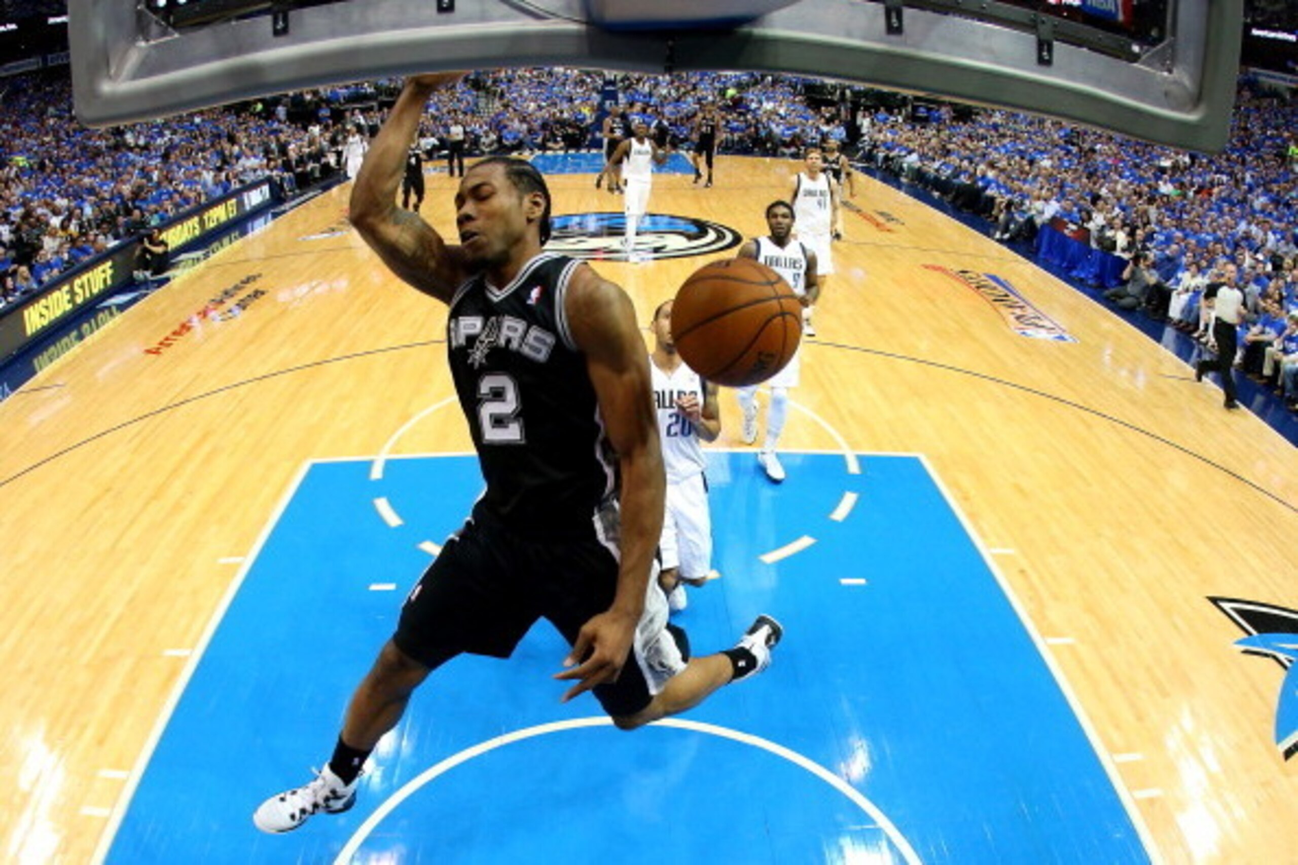 DALLAS, TX - MAY 02:  Kawhi Leonard #2 of the San Antonio Spurs makes a slam dunk against the Dallas Mavericks in Game Six of the Western Conference Quarterfinals during the 2014 NBA Playoffs at American Airlines Center on May 2, 2014 in Dallas, Texas. NO
