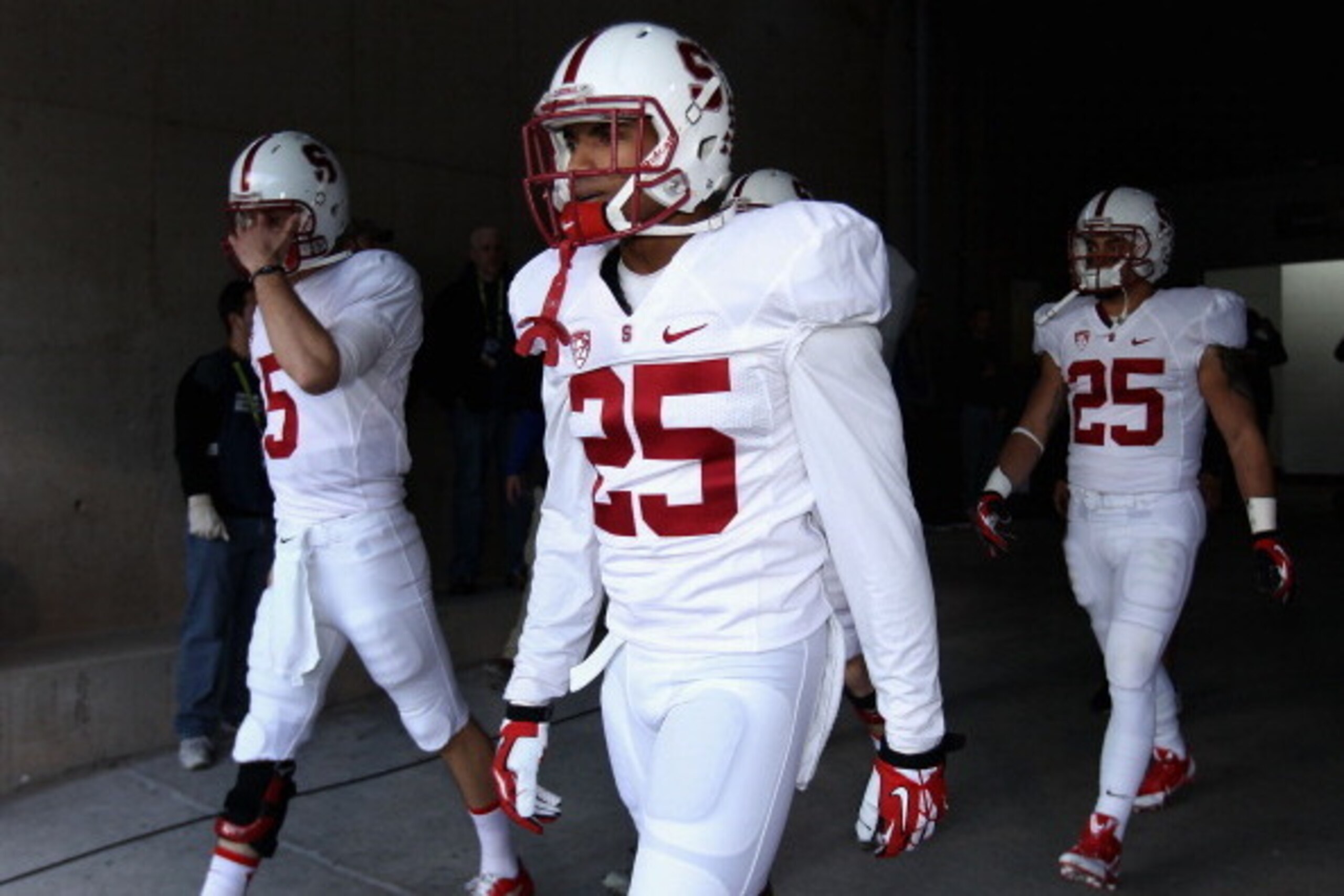 TEMPE, AZ - DECEMBER 07:  Cornerback Alex Carter #25 (C) of the Stanford Cardinal walks out onto the field with teammates before the Pac 12 Championship game against the Arizona State Sun Devils at Sun Devil Stadium on December 7, 2013 in Tempe, Arizona. 