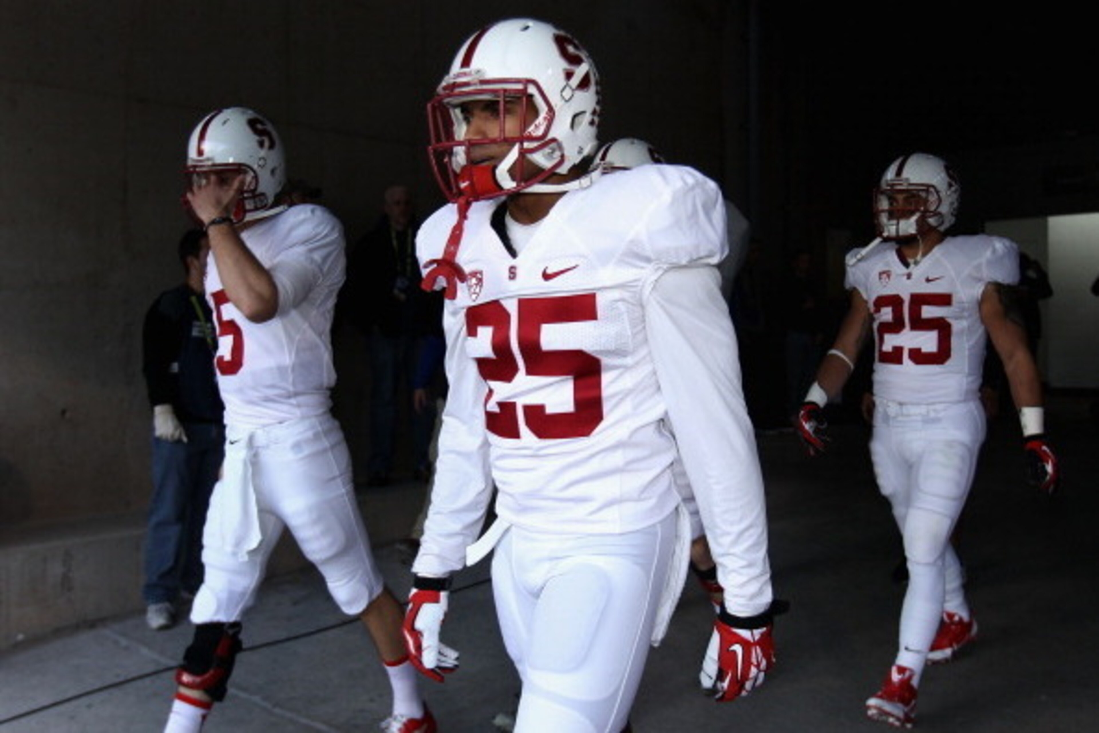 TEMPE, AZ - DECEMBER 07:  Cornerback Alex Carter #25 (C) of the Stanford Cardinal walks out onto the field with teammates before the Pac 12 Championship game against the Arizona State Sun Devils at Sun Devil Stadium on December 7, 2013 in Tempe, Arizona. 