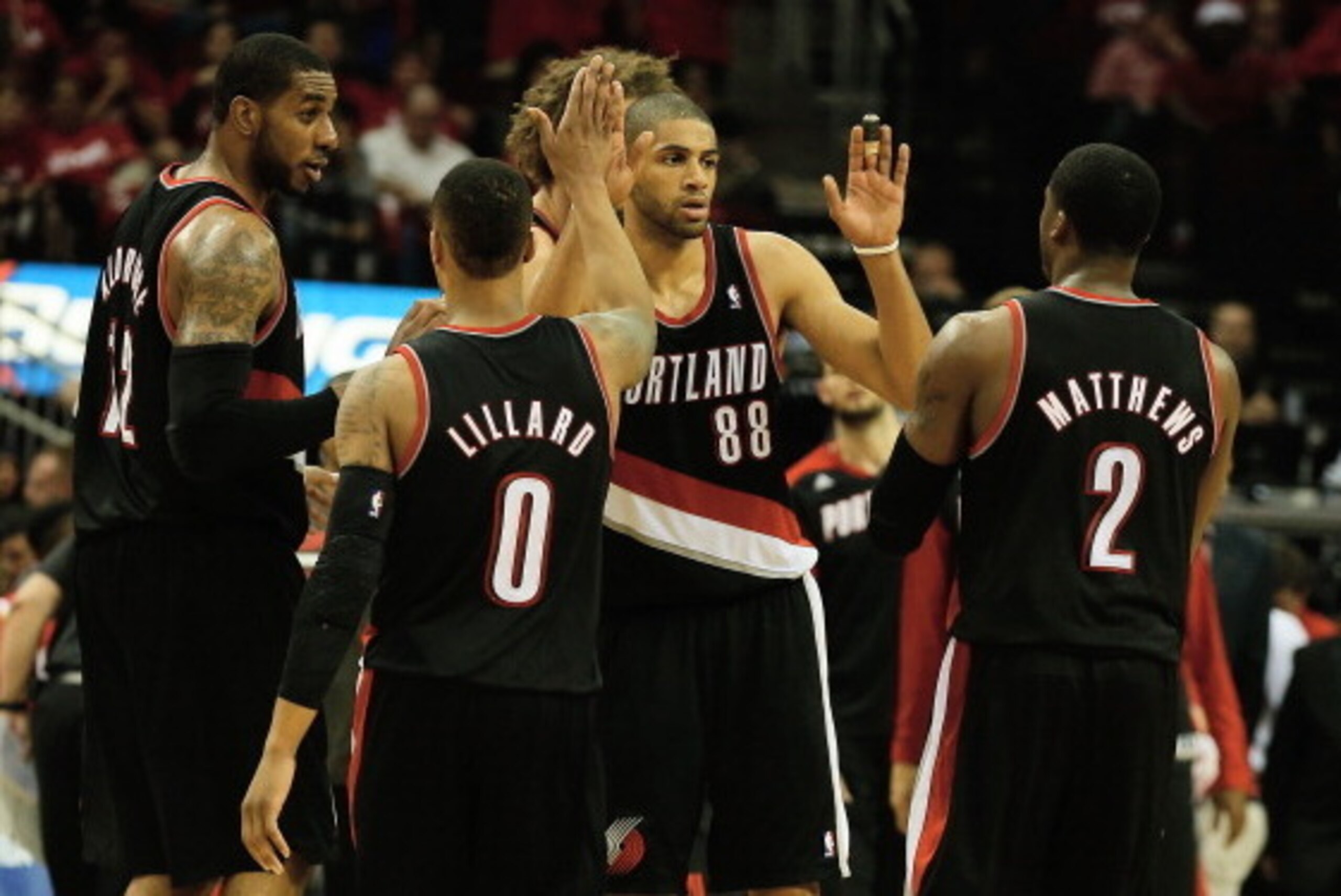 HOUSTON, TX - APRIL 23:  LaMarcus Aldridge #12, Damian Lillard #0, Robin Lopez #42, Nicolas Batum #88 and Wesley Matthews #2 of the Portland Trail Blazers celebrate a play on the court in the second half of the game against the Houston Rockets in Game Two