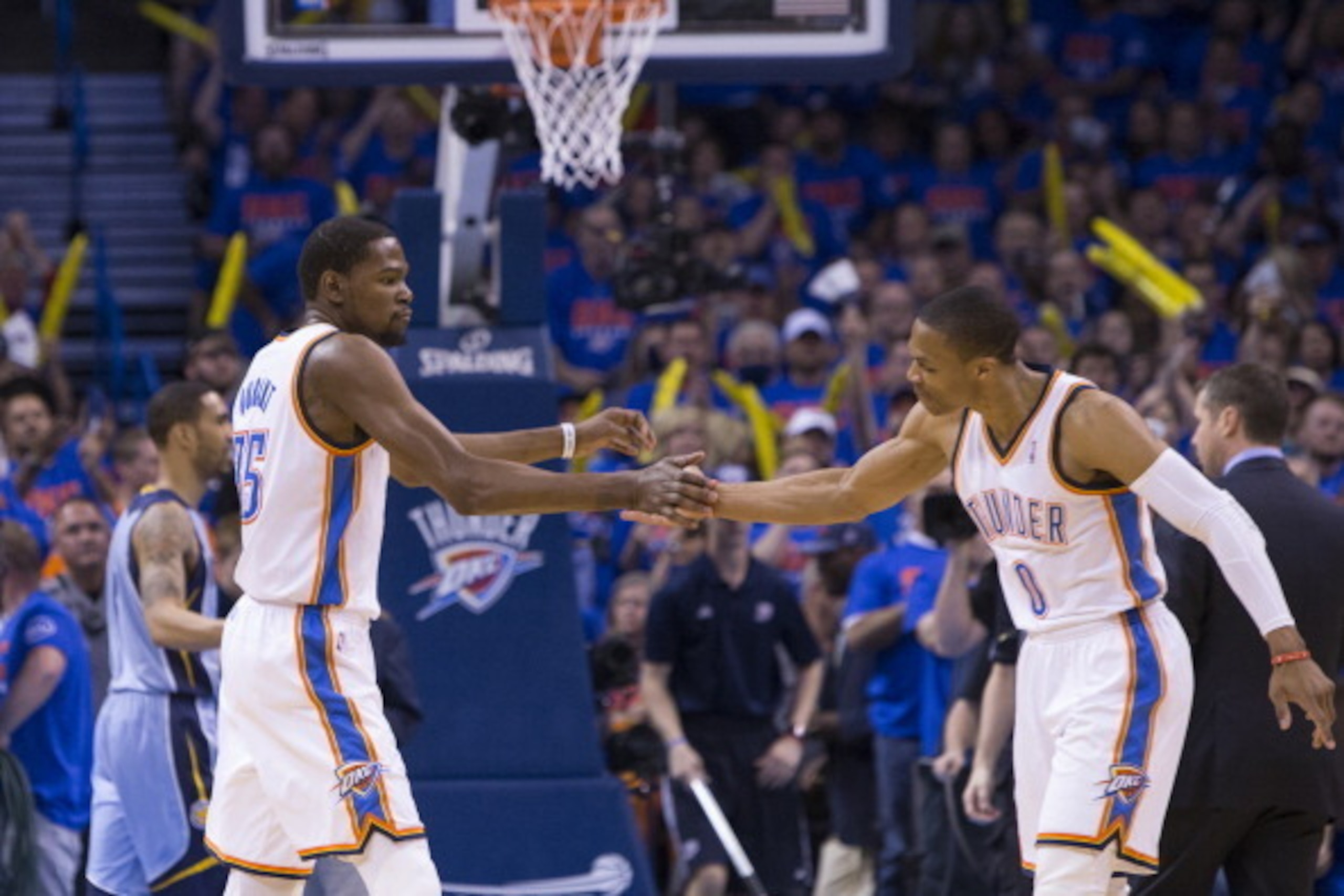 OKLAHOMA CITY, OK - May 3, 2014: Kevin Durant #35 and Russell Westbrook #0 of the Oklahoma City Thunder celebrate during a game against the Memphis Grizzlies in Game 7 of the Western Conference Quarterfinals during the 2014 NBA Playoffs at the Chesapeake OKLAHOMA CITY, OK - May 3, 2014: Kevin Durant #35 and Russell Westbrook #0 of the Oklahoma City Thunder celebrate during a game against the Memphis Grizzlies in Game 7 of the Western Conference Quarterfinals during the 2014 NBA Playoffs at the Chesapeake