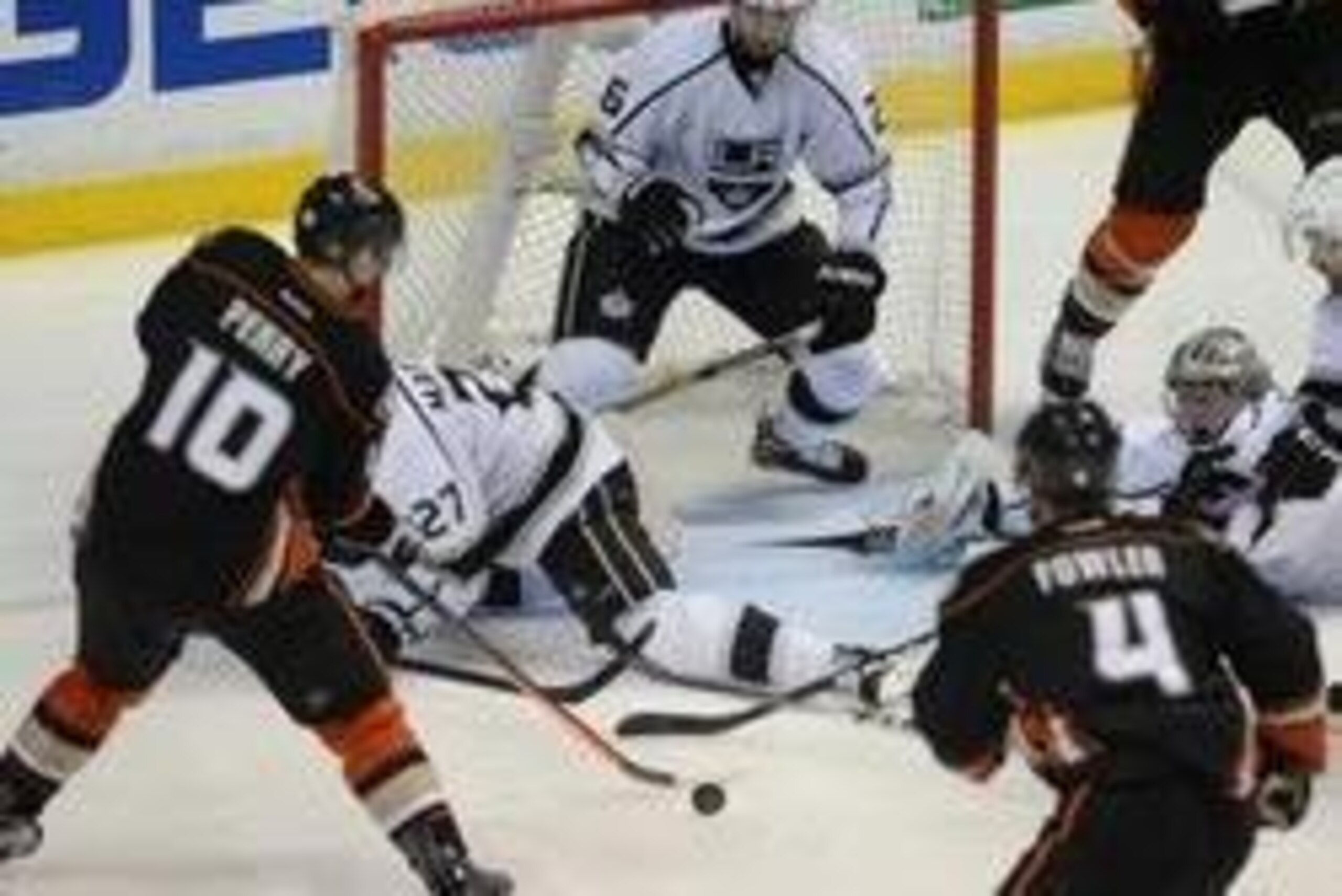 May 3, 2014; Anaheim, CA, USA; Los Angeles Kings defenseman Alec Martinez (27), defenseman Slava Voynov (26) and goalie Jonathan Quick (32) defend a shot by Anaheim Ducks right wing Corey Perry (10) in the overtime period of game one of the second round o