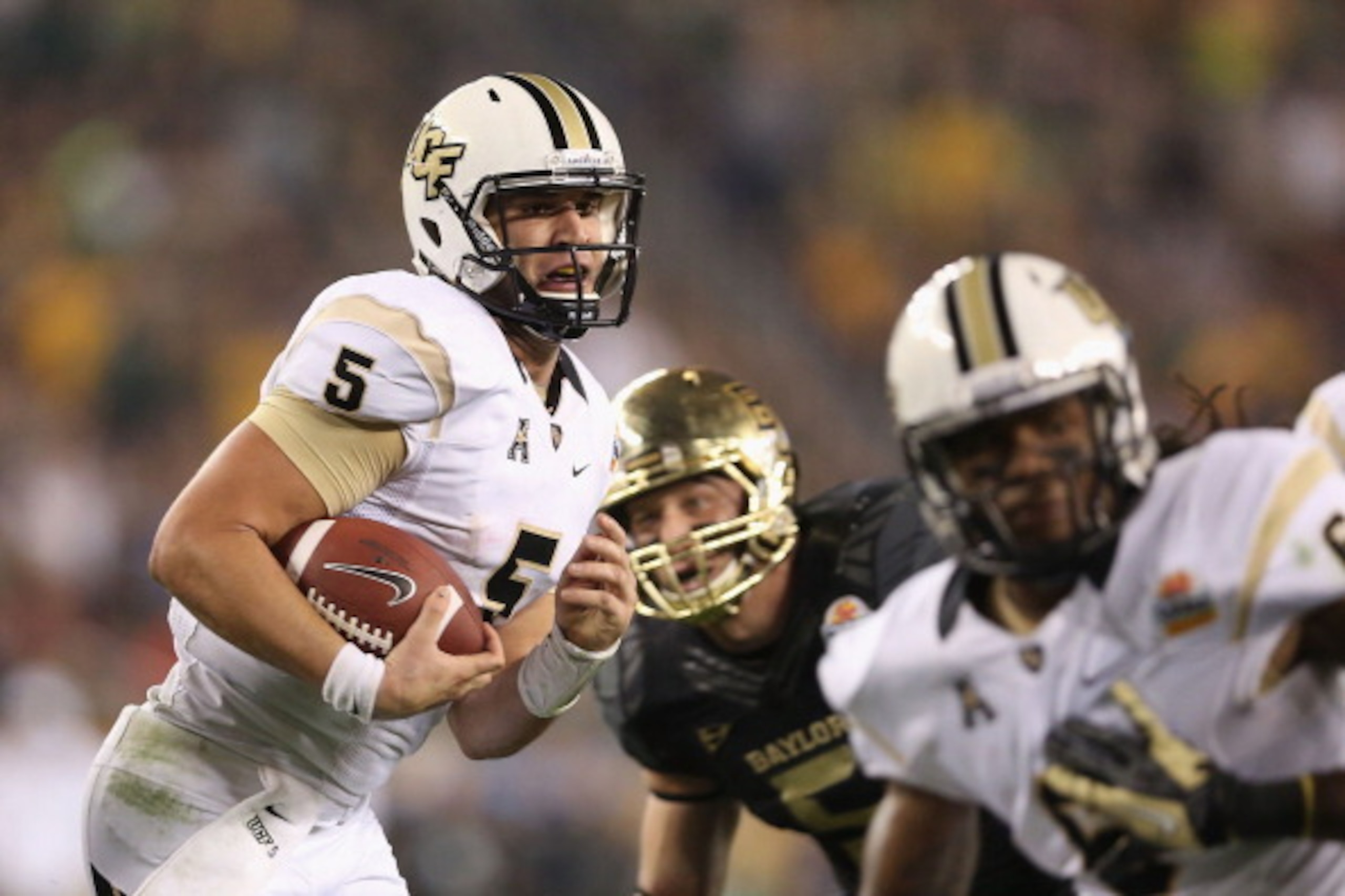 GLENDALE, AZ - JANUARY 01:  Quarterback Blake Bortles #5 of the UCF Knights runs with the football against the Baylor Bears during the Tostitos Fiesta Bowl at University of Phoenix Stadium on January 1, 2014 in Glendale, Arizona.  (Photo by Christian Pete
