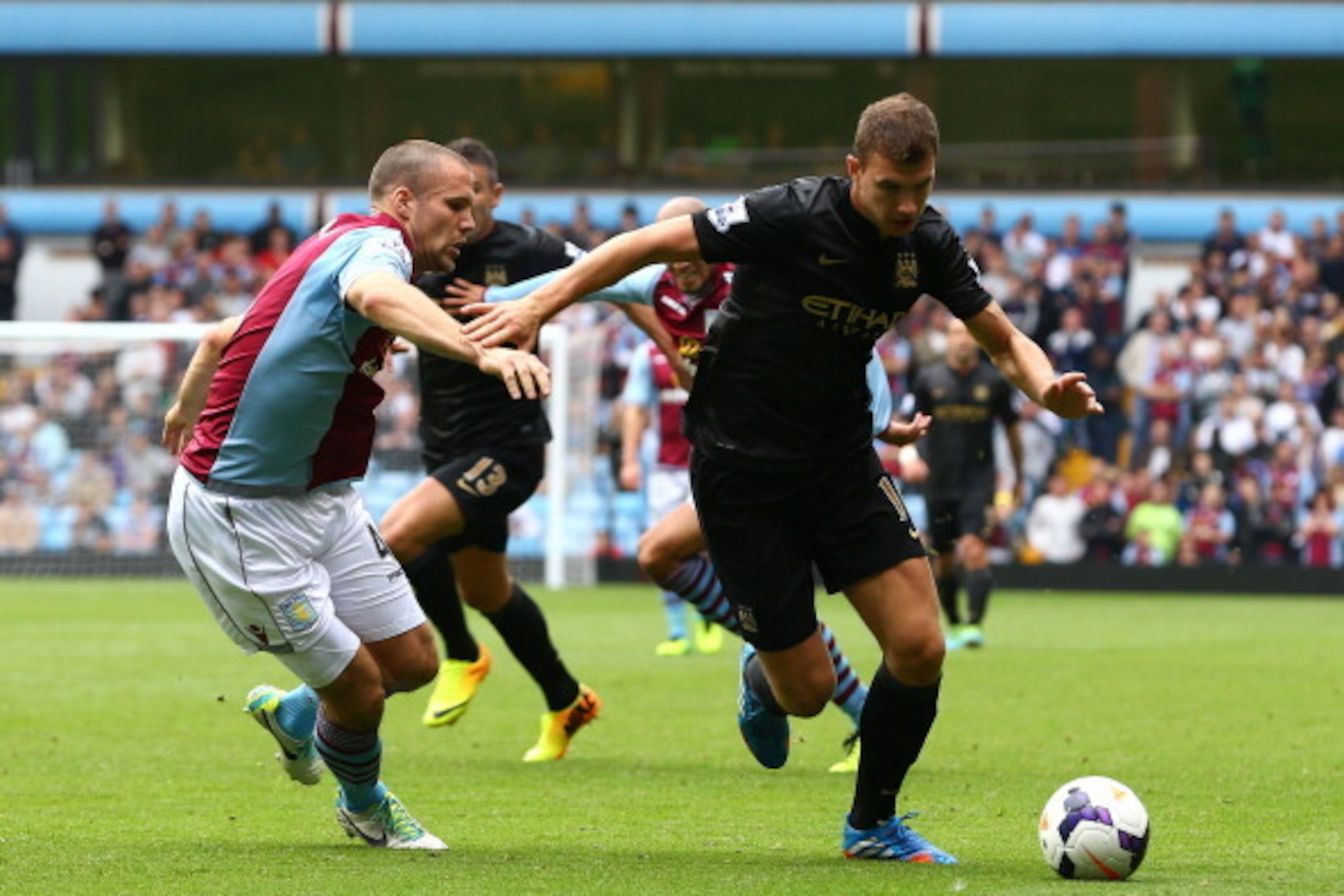 BIRMINGHAM, ENGLAND - SEPTEMBER 28: Edin Dzeko of Manchester City battles with Ron Vlaar of Aston Villa during the Barclays Premier League match between Aston Villa and Manchester City at Villa Park on September 28, 2013 in Birmingham, England. (Photo b BIRMINGHAM, ENGLAND - SEPTEMBER 28: Edin Dzeko of Manchester City battles with Ron Vlaar of Aston Villa during the Barclays Premier League match between Aston Villa and Manchester City at Villa Park on September 28, 2013 in Birmingham, England. (Photo b