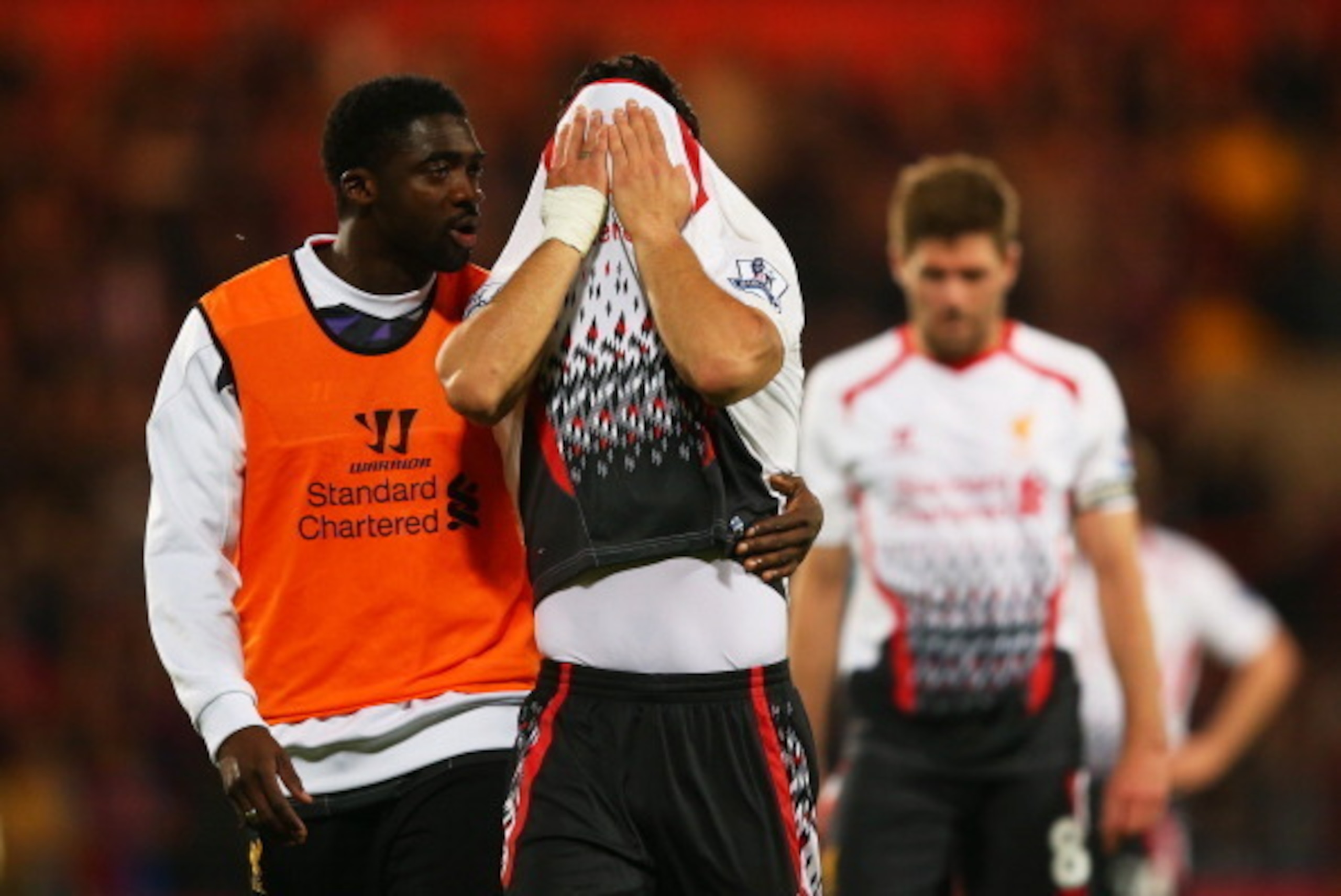 LONDON, ENGLAND - MAY 05:  Kolo Toure of Liverpool consoles the dejected Luis Suarez of Liverpool following their team's 3-3 draw during the Barclays Premier League match between Crystal Palace and Liverpool at Selhurst Park on May 5, 2014 in London, Engl