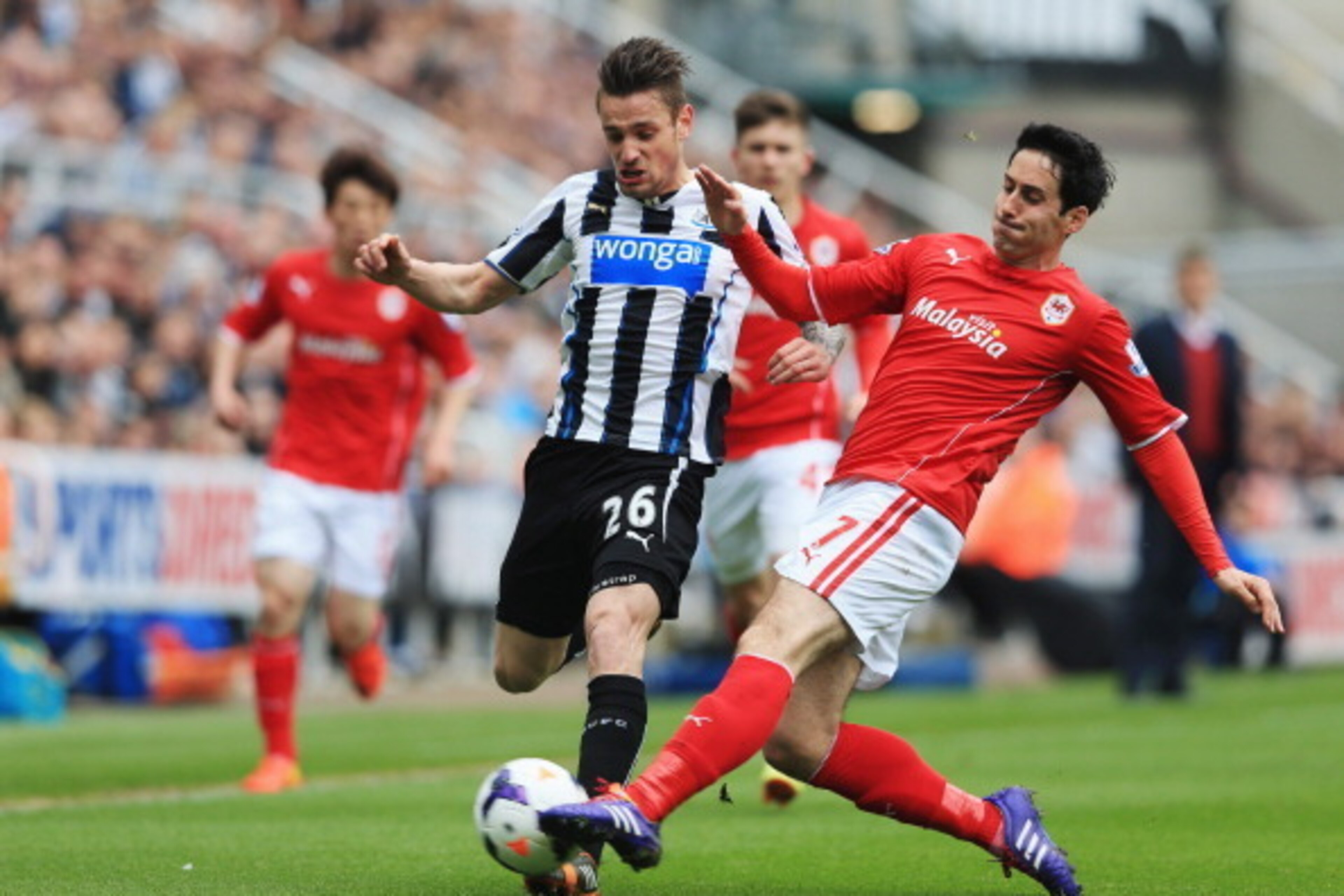 NEWCASTLE UPON TYNE, ENGLAND - MAY 03: Mathieu Debuchy of Newcastle United is tackled by Peter Whittingham of Cardiff City during the Barclays Premier League match between Newcastle United and Cardiff City at St James' Park on May 3, 2014 in Newcastle up NEWCASTLE UPON TYNE, ENGLAND - MAY 03: Mathieu Debuchy of Newcastle United is tackled by Peter Whittingham of Cardiff City during the Barclays Premier League match between Newcastle United and Cardiff City at St James' Park on May 3, 2014 in Newcastle up