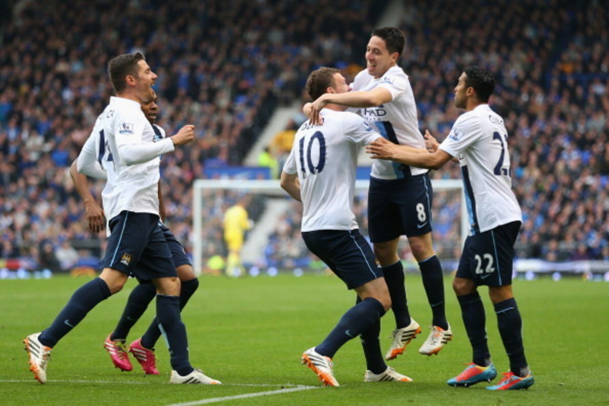 LIVERPOOL, ENGLAND - MAY 03: Edin Dzeko of Manchester City celebrates scoring his team's third goal with his team-mates during the Barclays Premier League match between Everton and Manchester City at Goodison Park on May 3, 2014 in Liverpool, England. ( LIVERPOOL, ENGLAND - MAY 03: Edin Dzeko of Manchester City celebrates scoring his team's third goal with his team-mates during the Barclays Premier League match between Everton and Manchester City at Goodison Park on May 3, 2014 in Liverpool, England. (