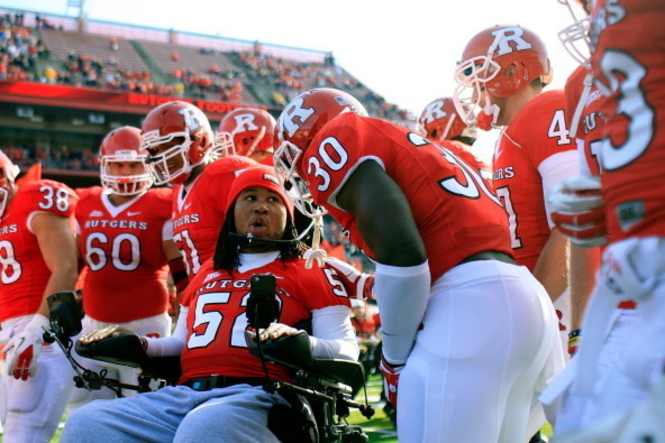 NEW BRUNSWICK, NJ - NOVEMBER 19:  Eric LeGrand #52 of the Rutgers Scarlet Knights posses for a photo with teammates on Senior's Day at center field before a game against Cincinnati Bearcats at Rutgers Stadium on November 19, 2011 in New Brunswick, New Jer