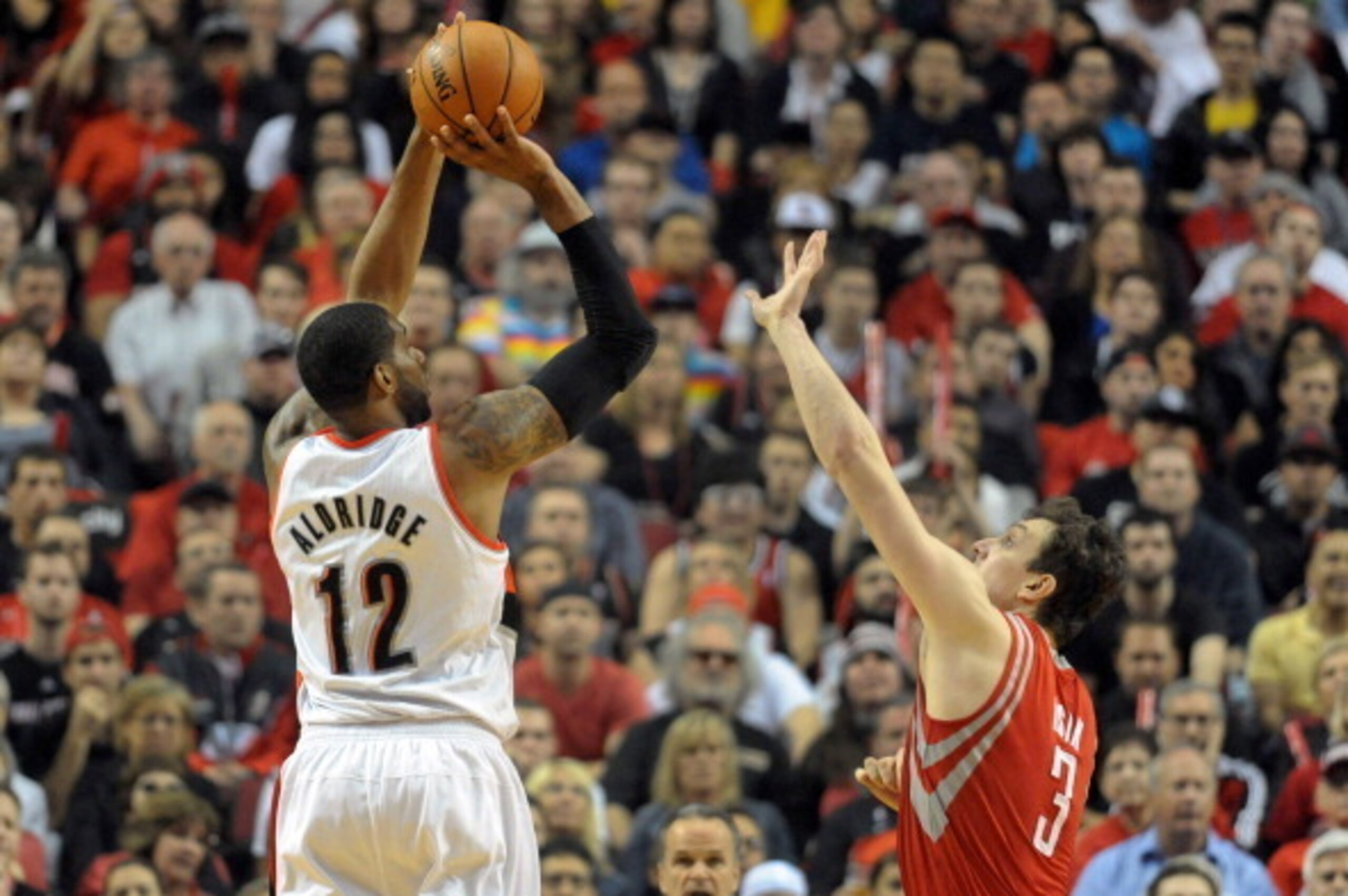 PORTLAND, OR - MAY 2: LaMarcus Aldridge #12 of the Portland Trail Blazers hits a shot over Omer Asik #3 of the Houston Rockets in the first quarter of Game Six of the Western Conference Quarterfinals during the 2014 NBA Playoffs at the Moda Center on May 