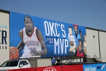 EDMOND, OK - MAY 6:  A banner celebrating Oklahoma City Thunder forward Kevin Durant being named the winner of the Maurice Podoloff Trophy as the 2013-14 Kia NBA Most Valuable Player is dropped on May 6, 2014 at the Thunder Events Center in Edmond, Oklaho