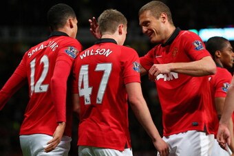 MANCHESTER, ENGLAND - MAY 06:  James Wilson of Manchester United celebrates scoring the second goal with team-mate Nemanja Vidic during the Barclays Premier League match between Manchester United and Hull City at Old Trafford on May 6, 2014 in Manchester,