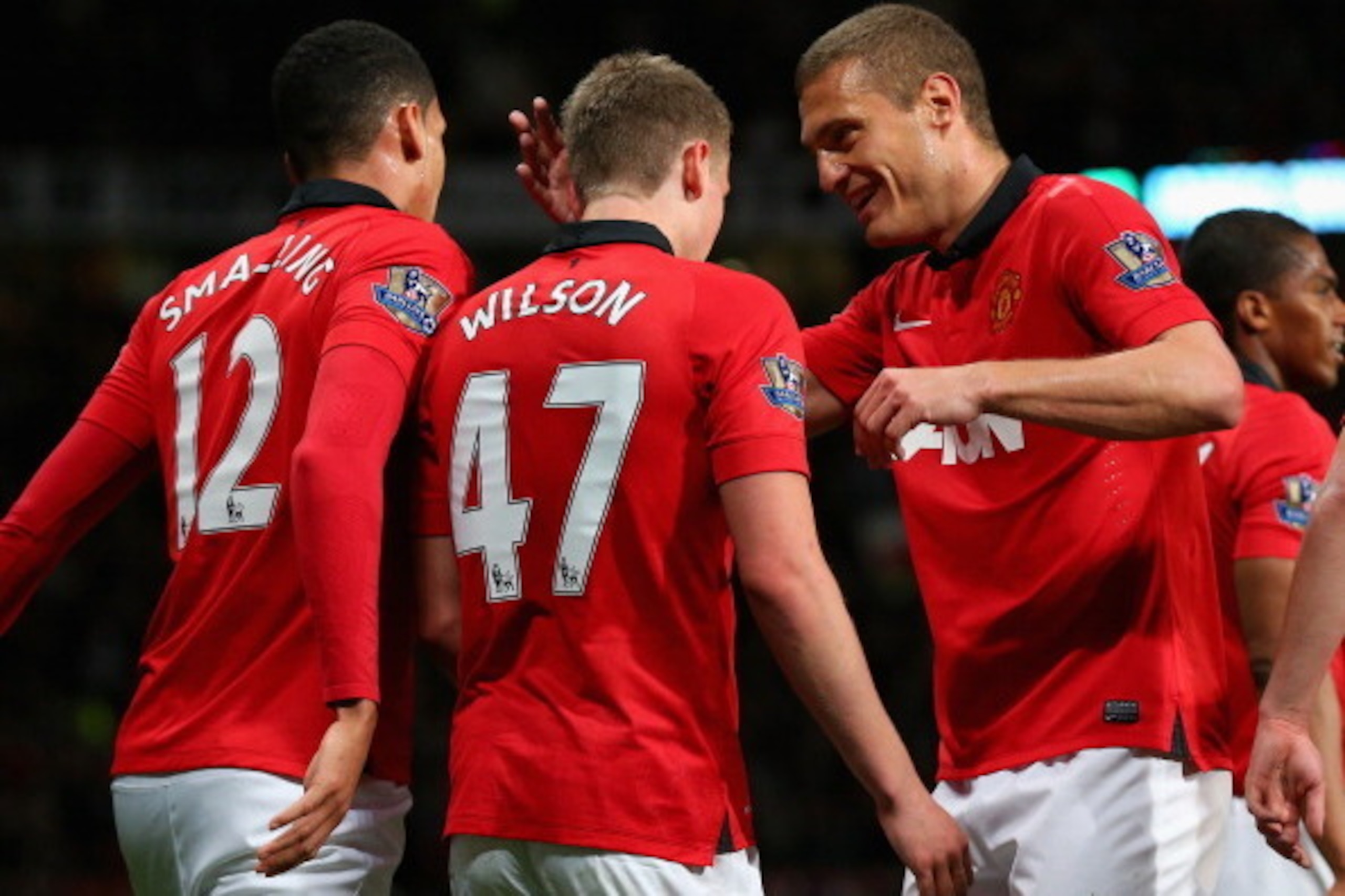 MANCHESTER, ENGLAND - MAY 06:  James Wilson of Manchester United celebrates scoring the second goal with team-mate Nemanja Vidic during the Barclays Premier League match between Manchester United and Hull City at Old Trafford on May 6, 2014 in Manchester,