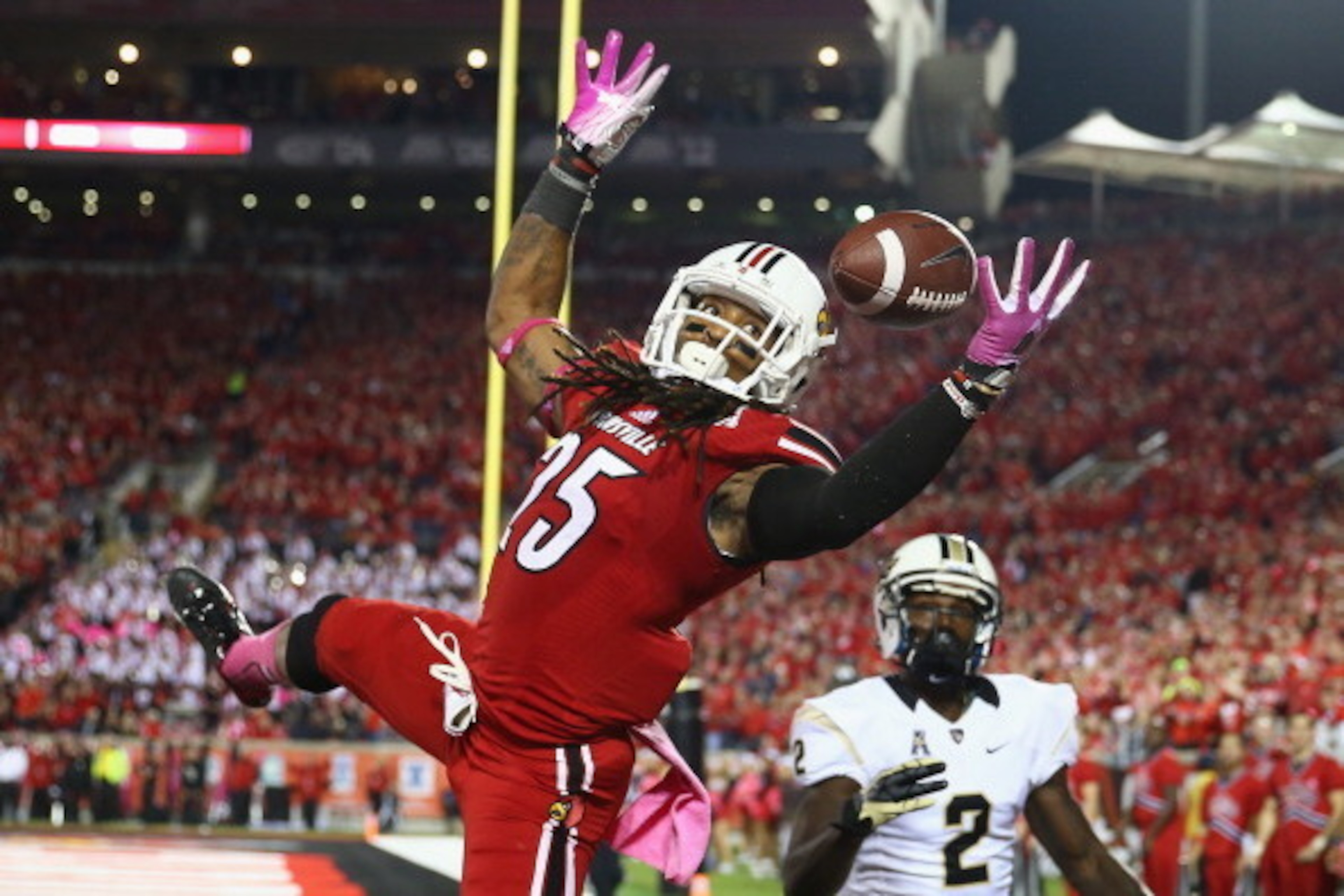 LOUISVILLE, KY - OCTOBER 18:  Calvin Pryor #25 of the Louisville Cardinals intercepts a pass in the end zone during the game against the Central Florida Knights at Papa John's Cardinal Stadium on October 18, 2013 in Louisville, Kentucky.  (Photo by Andy L