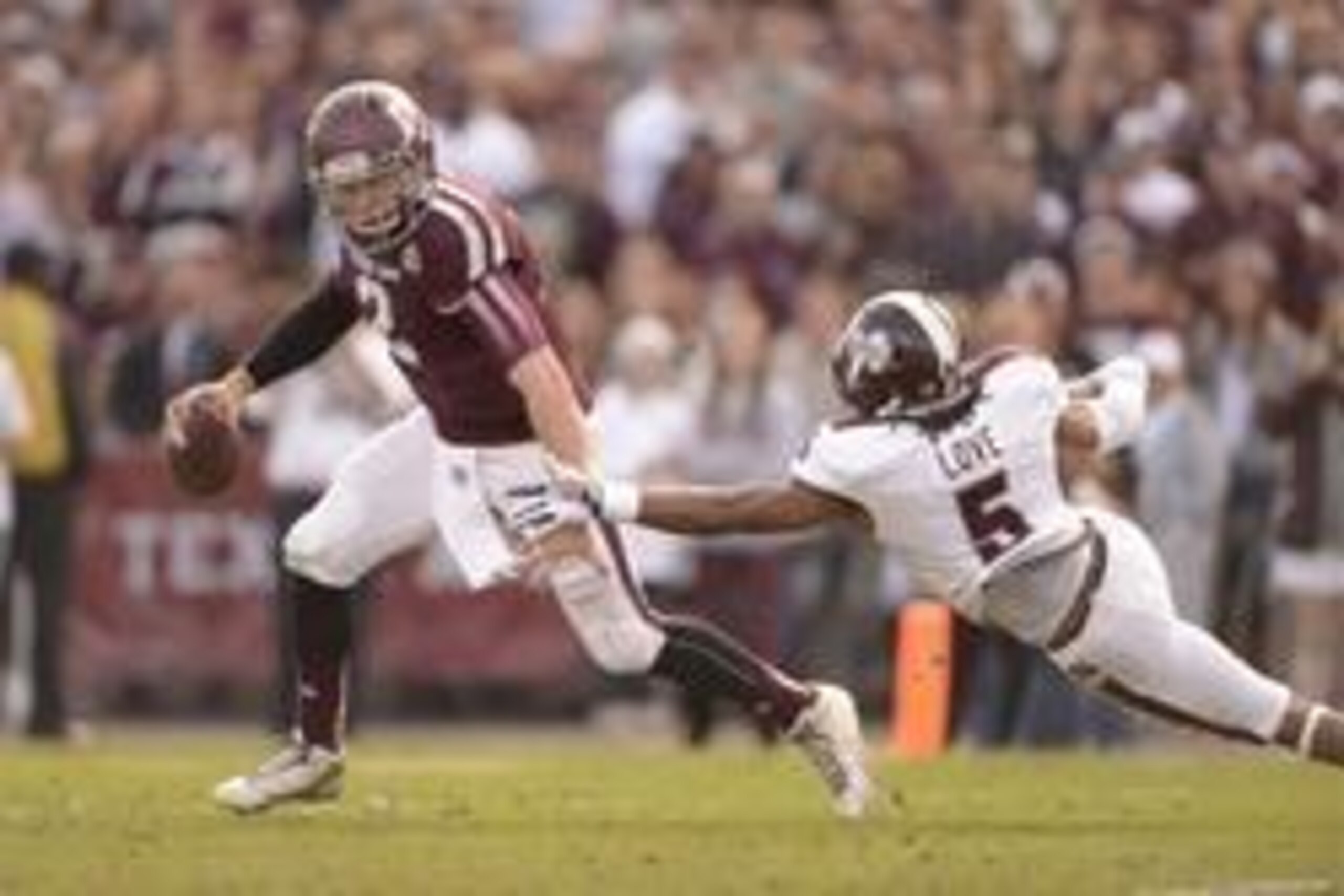 Nov 9, 2013; College Station, TX, USA; Texas A&M Aggies quarterback Johnny Manziel (2) breaks a tackle by Mississippi State Bulldogs defensive back Jamerson Love (5) during the second quarter at Kyle Field. Mandatory Credit: Thomas Campbell-USA TODAY Spor