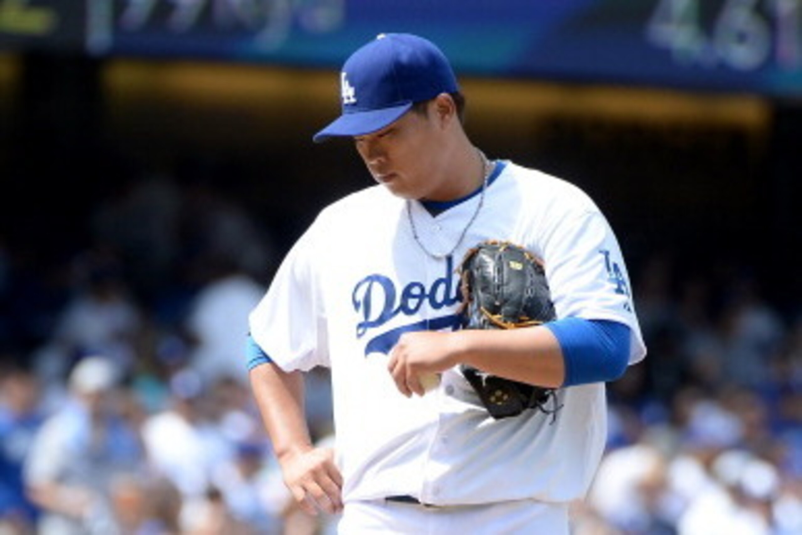 LOS ANGELES, CA - APRIL 04:  Hyun-Jin Ryu #99 of the Los Angeles Dodgers reacts after a second run in the inning to the San Francisco Giants to trail 8-0 during the second inning on opening day at Dodger Stadium on April 4, 2014 in Los Angeles, California