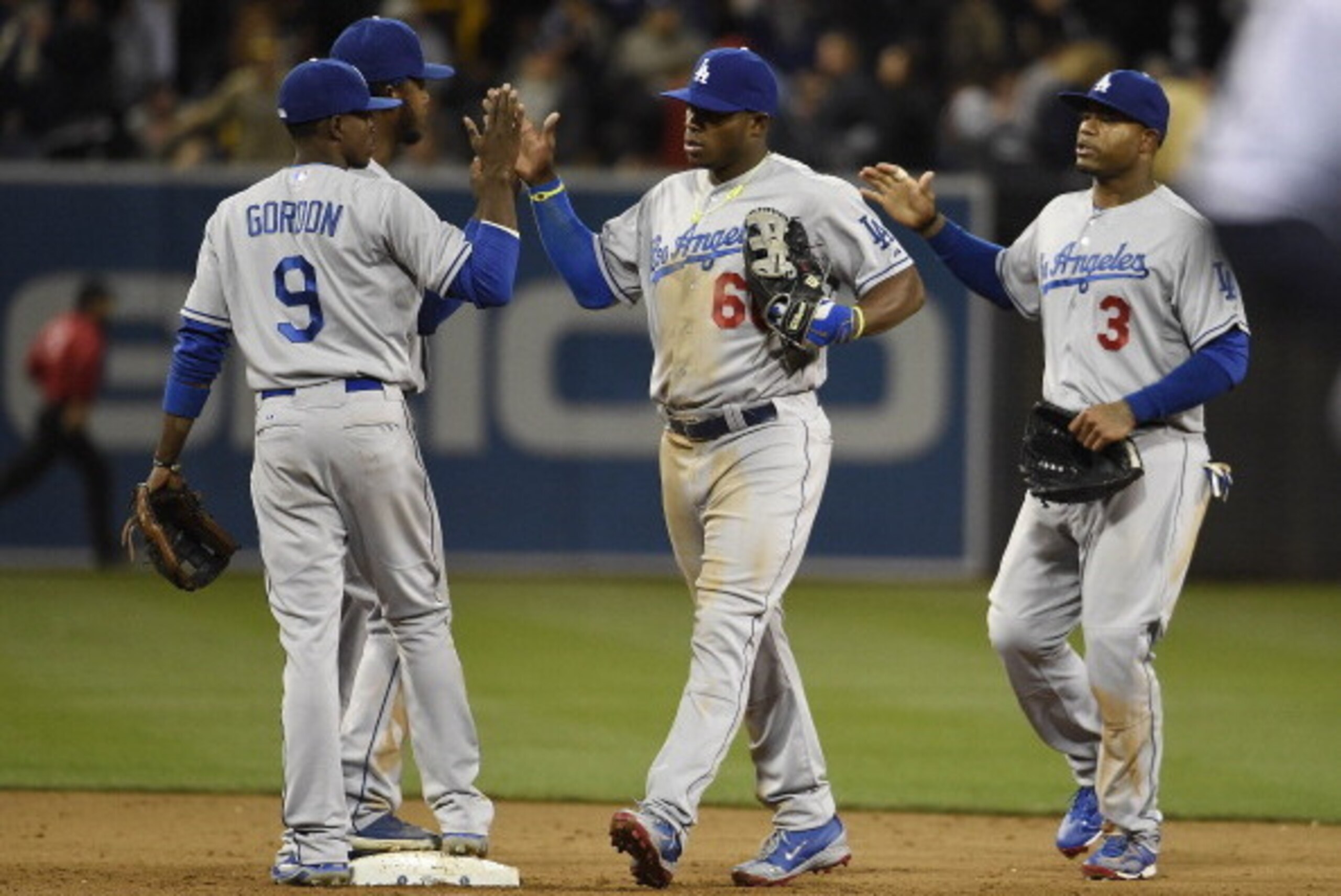 SAN DIEGO, CA - APRIL 2:  Los Angeles Dodgers players high-five after beating the San Diego Padres 5-1 in a baseball game at Petco Park April 2, 2014 in San Diego, California.  (Photo by Denis Poroy/Getty Images)
