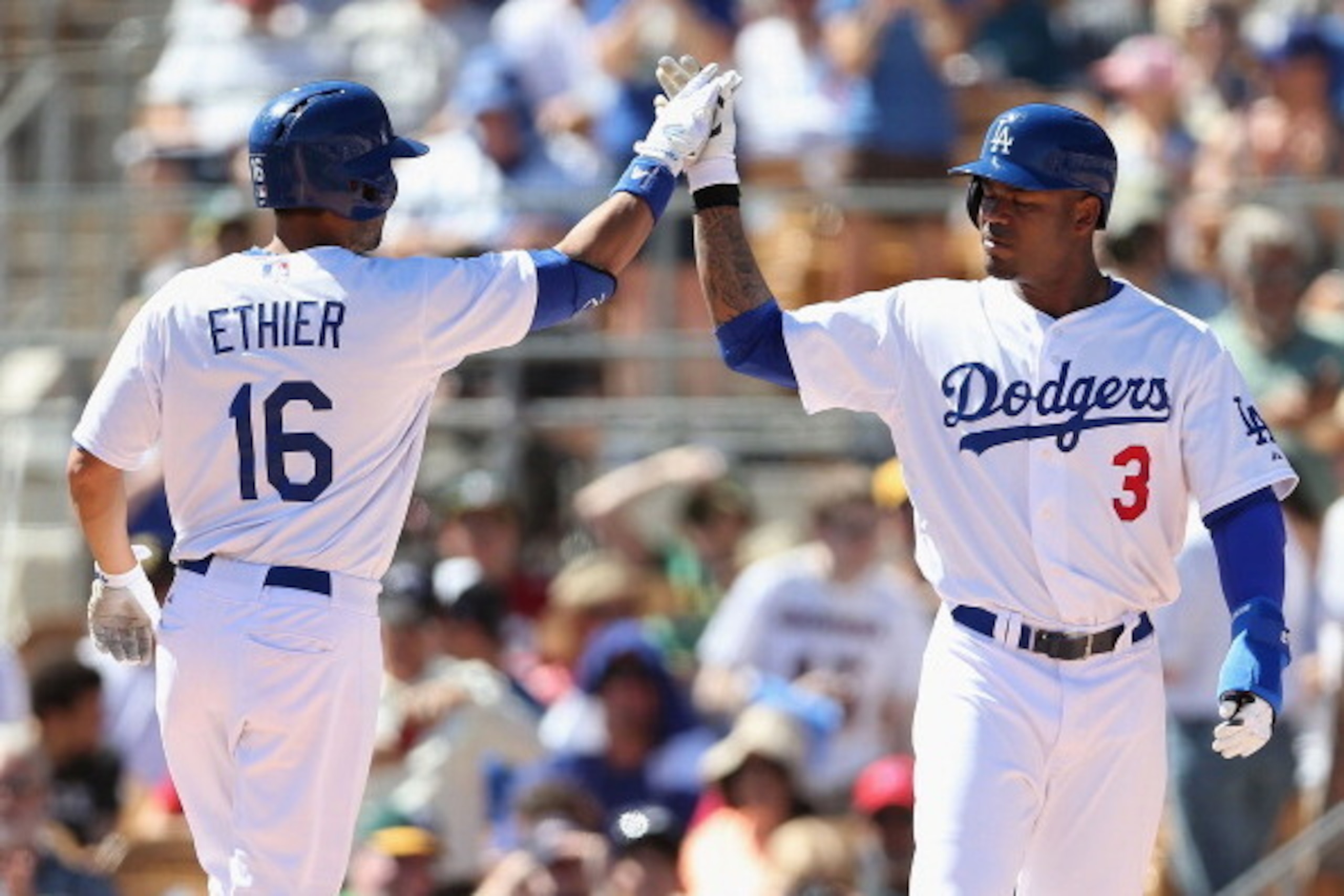 GLENDALE, AZ - MARCH 10:  Carl Crawford #3 of the Los Angeles Dodgers high fives Andre Ethier #16 after Ethier hit a three run home-run against the Oakland Athletics during the first inning of the spring training game at Camelback Ranch on March 10, 2014