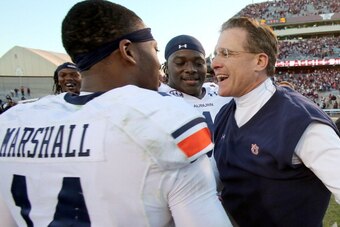 HOUSTON, TX - OCTOBER 19: Nick Marshall #14 of the Auburn Tigers hugs head coach Gus Malzahn of the Auburn Tigers after they defeated the Texas A&M Aggies on October 19, 2013 at Kyle Field in College Station, Texas. Auburn Tigers won 45 to 41.(Photo by Th