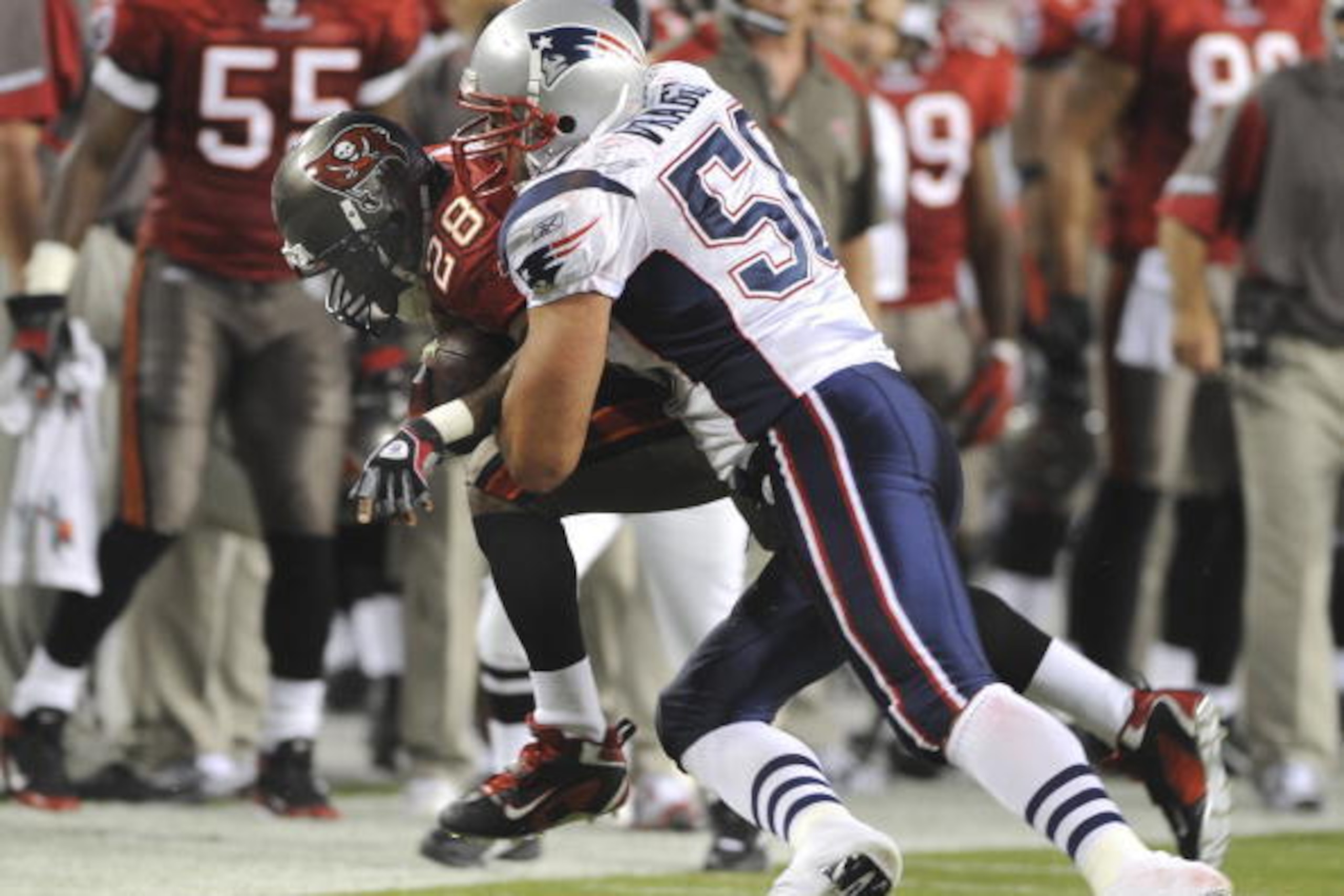 TAMPA, FL - AUGUST 17: Linebacker Mike Vrabel #50 of the New England Patriots tackles running back Warrick Dunn #28 of the Tampa Bay Buccaneers at Raymond James Stadium on August 17, 2008 in Tampa, Florida.   (Photo by Al Messerschmidt/Getty Images)