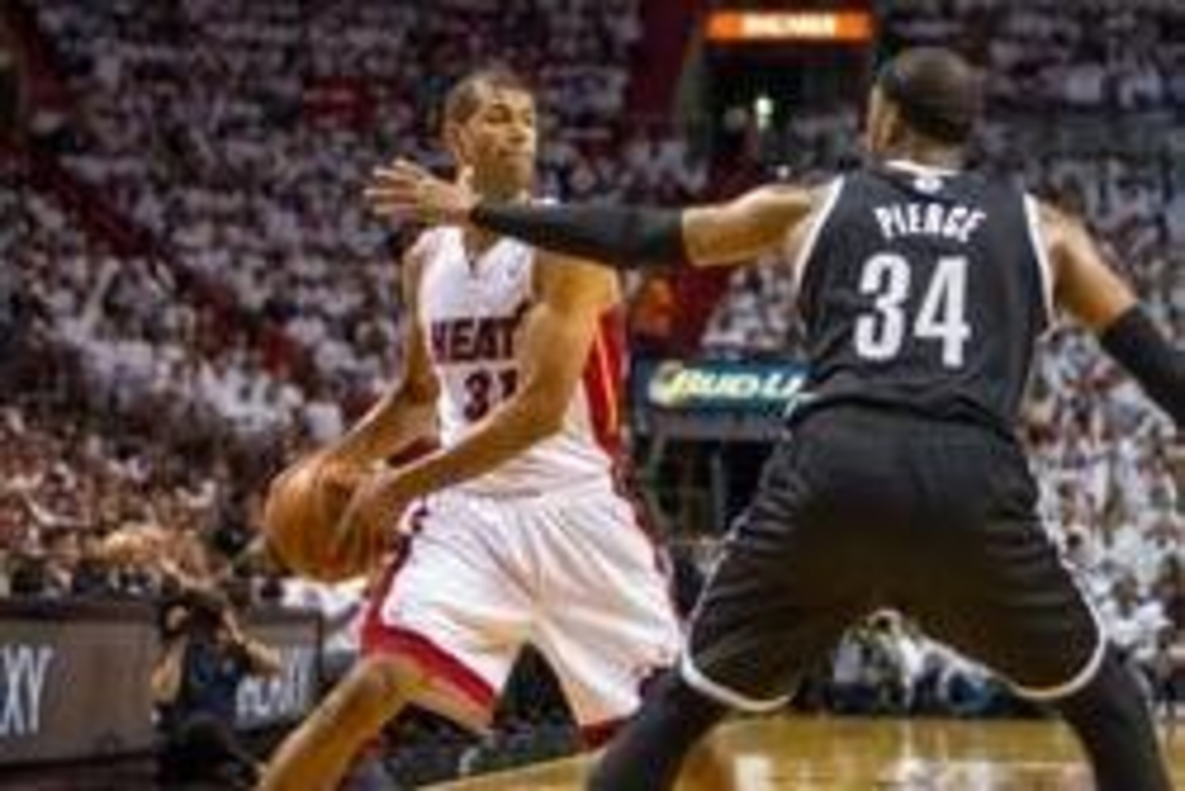 May 6, 2014; Miami, FL, USA; Miami Heat forward Shane Battier (31) is pressured by Brooklyn Nets forward Paul Pierce (34) during the first half in game one of the second round of the 2014 NBA Playoffs at American Airlines Arena. Mandatory Credit: Steve Mi