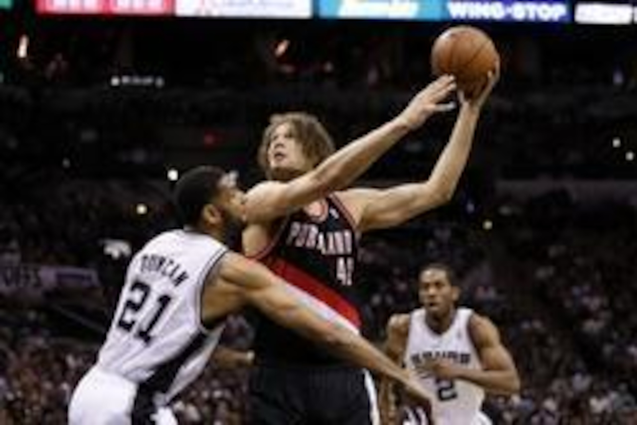 May 6, 2014; San Antonio, TX, USA; Portland Trail Blazers center Robin Lopez (42) shoots the ball against San Antonio Spurs forward Tim Duncan (21) in game one of the second round of the 2014 NBA Playoffs at AT&T Center. Mandatory Credit: Soobum Im-USA TO