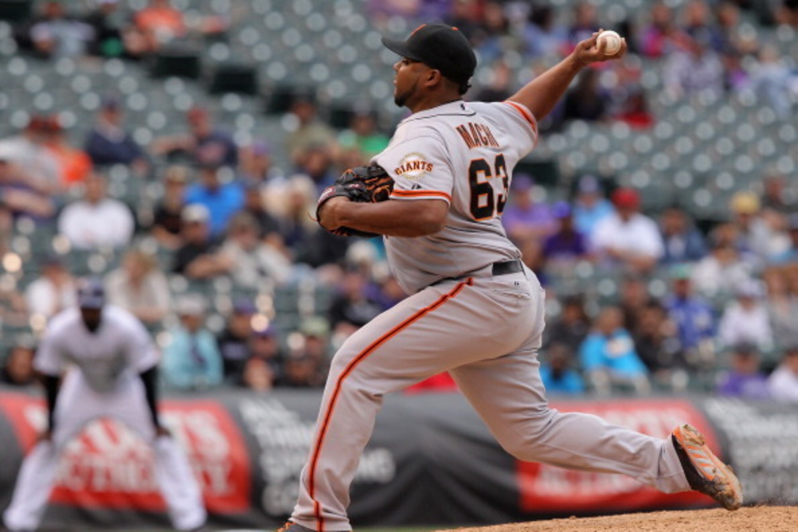 DENVER, CO - APRIL 23:  Relief pitcher Jean Machi #63 of the San Francisco Giants delivers against the Colorado Rockies at Coors Field on April 23, 2014 in Denver, Colorado. Machi earned the win as the Giants defeated the Rockies 12-10 in 11 innings.  (Ph
