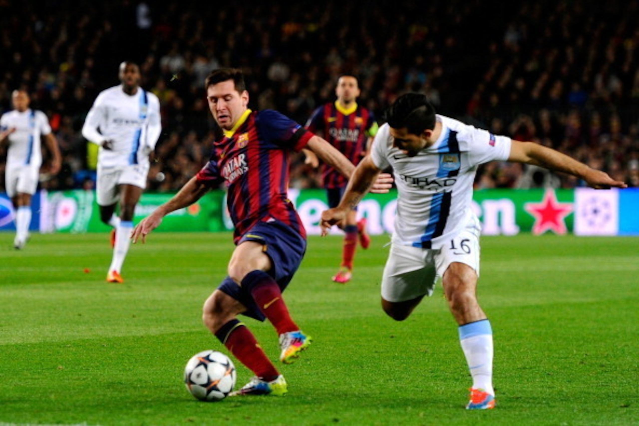 BARCELONA, SPAIN - MARCH 12:  Lionel Messi of Barcelona is challenged by Sergio Aguero of Manchester City during the UEFA Champions League Round of 16, second leg match between FC Barcelona and Manchester City  at Camp Nou on March 12, 2014 in Barcelona, 