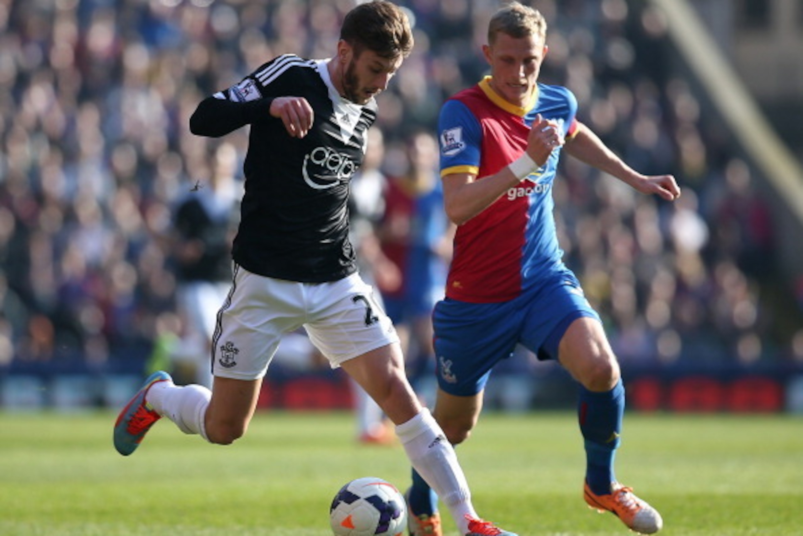 LONDON, ENGLAND - MARCH 08: Adam Lallana of Southampton looks to get away from Palace's Dean Moxey during the Barclays Premier League match between Crystal Palace and Southampton at Selhurst Park on March 08, 2014 in London, England. (Photo by Charlie Cro