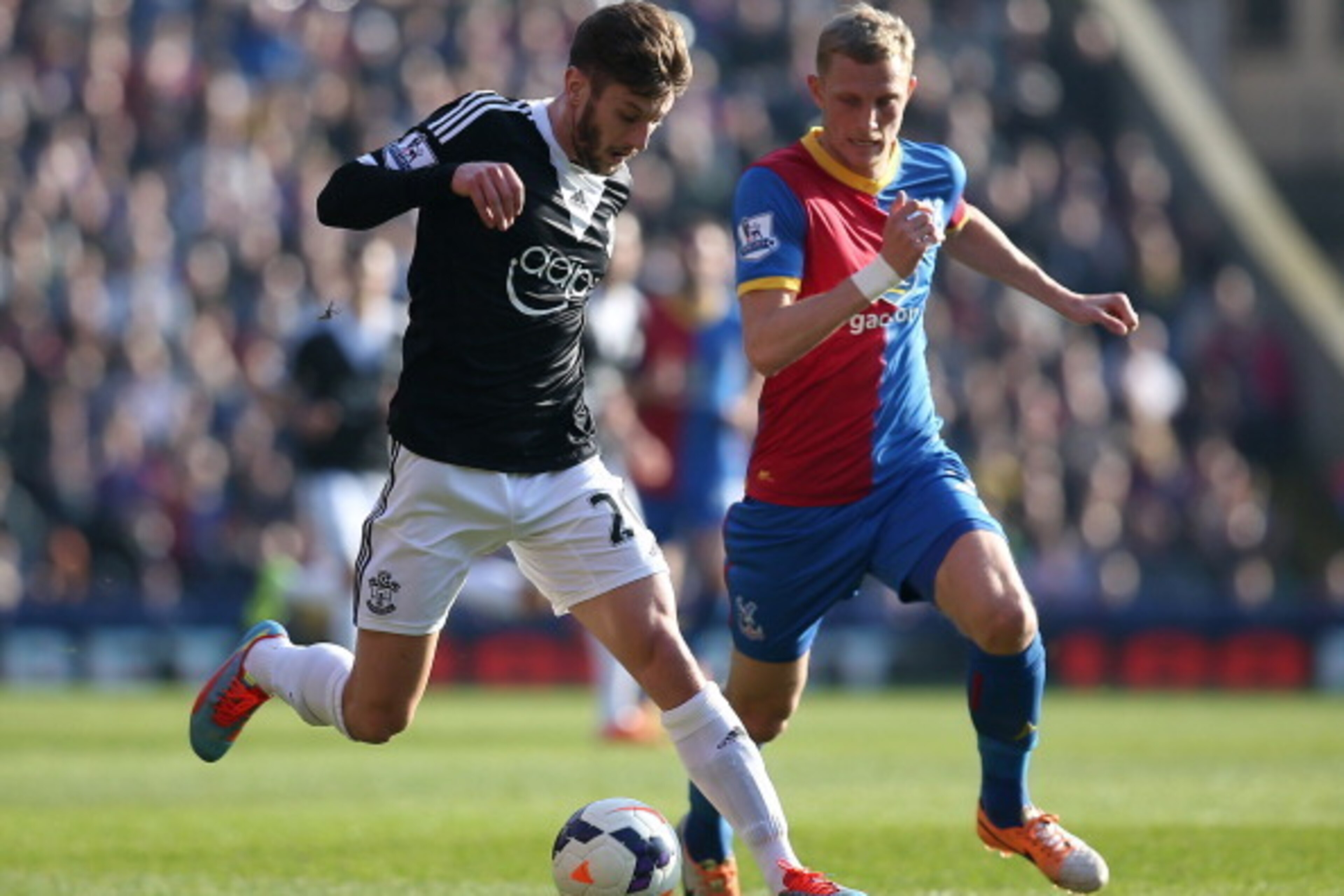 LONDON, ENGLAND - MARCH 08: Adam Lallana of Southampton looks to get away from Palace's Dean Moxey during the Barclays Premier League match between Crystal Palace and Southampton at Selhurst Park on March 08, 2014 in London, England. (Photo by Charlie Cro