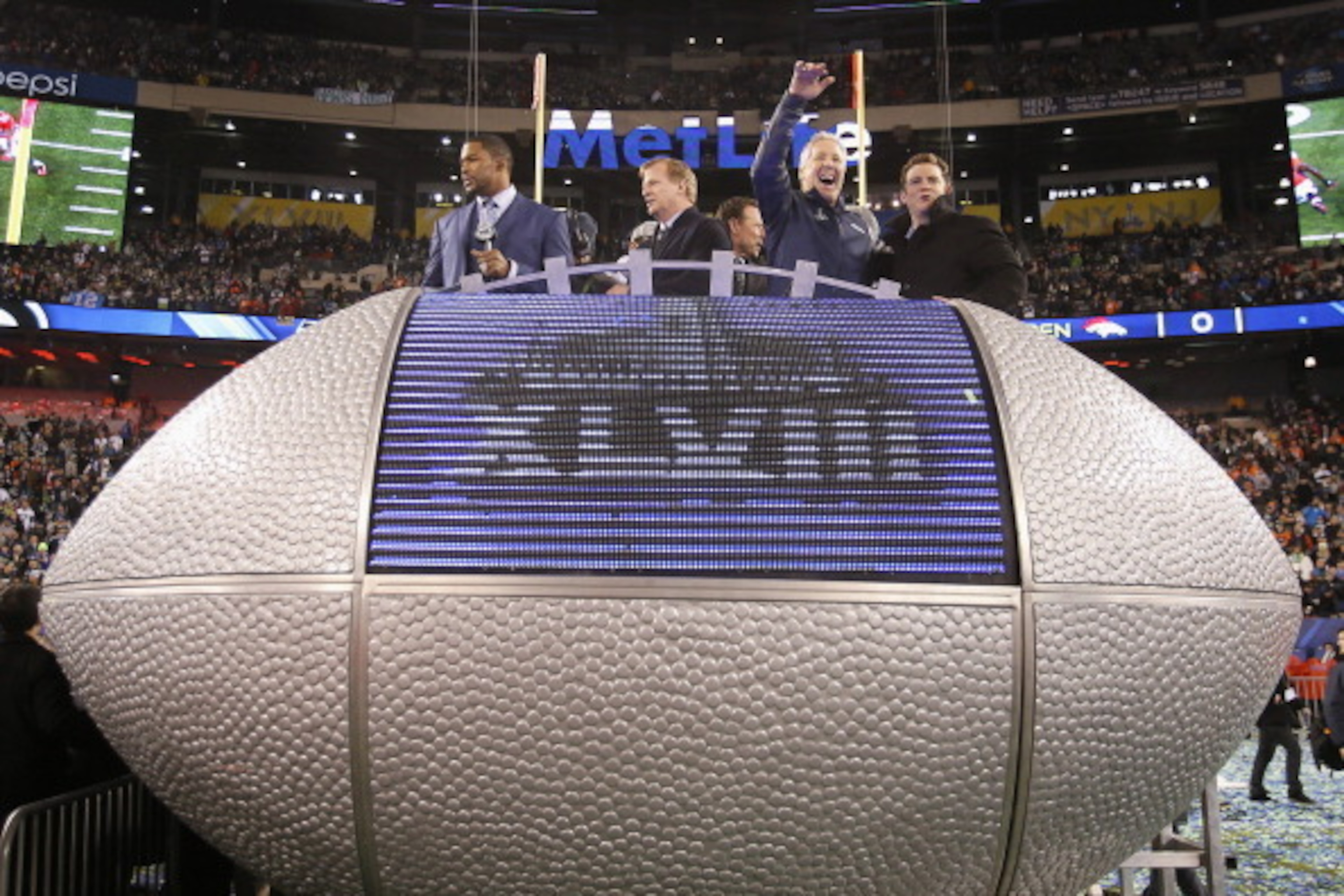 EAST RUTHERFORD, NJ - FEBRUARY 02:  (L-R) Fox sportscaster Michael Strahan, NFL Commissioner Roger Goodell,  head coach Pete Carroll and Seattle Seahawks General ManagerJohn Schneider celebrate after the Seahawks 43-8 victory over the Denver Broncos durin