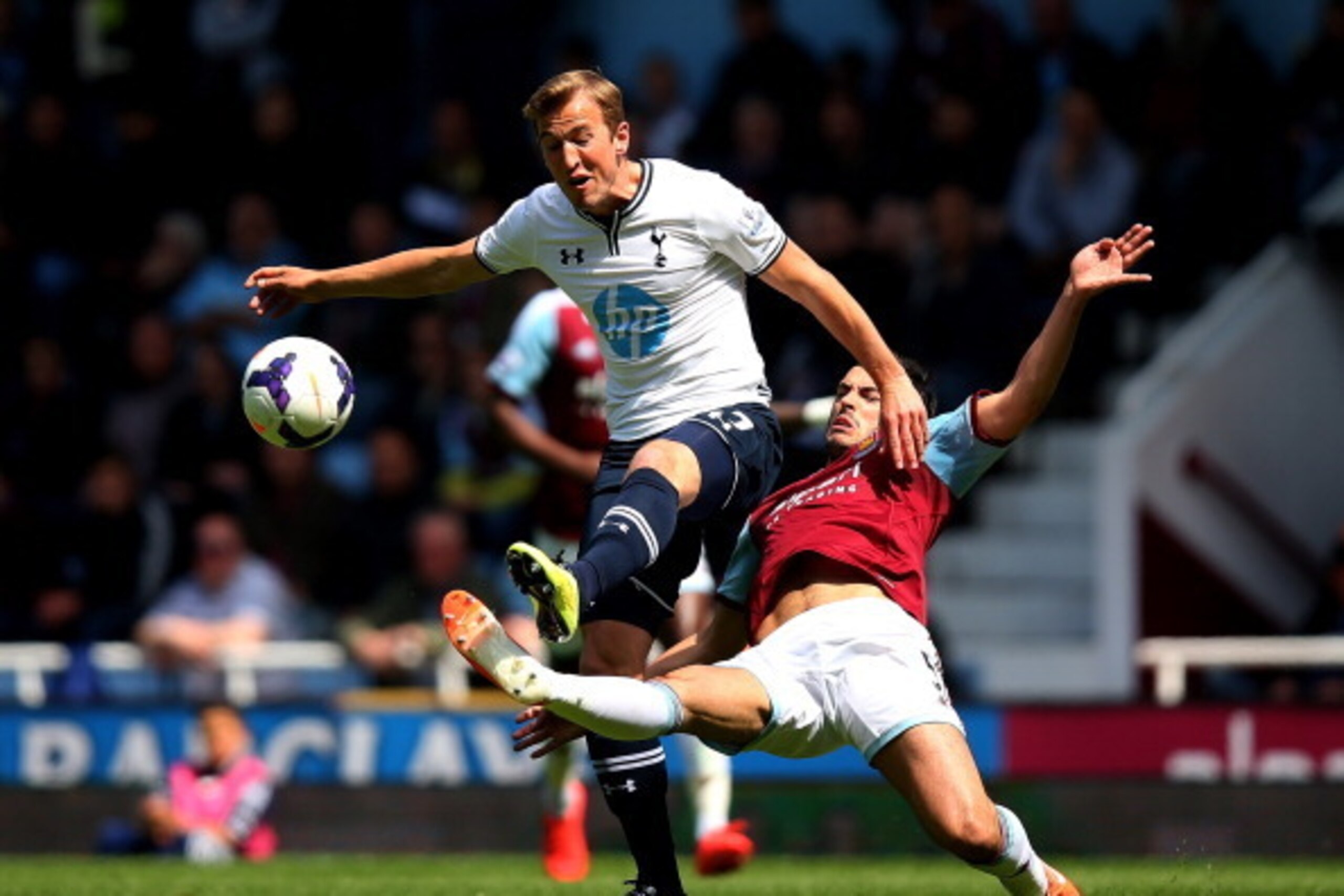 LONDON, ENGLAND - MAY 03:  Harry Kane of Spurs is tackled by James Tomkins of West Ham during the Barclays Premier League match between West Ham United and Tottenham Hotspur at Boleyn Ground on May 3, 2014 in London, England.  (Photo by Bryn Lennon/Getty 