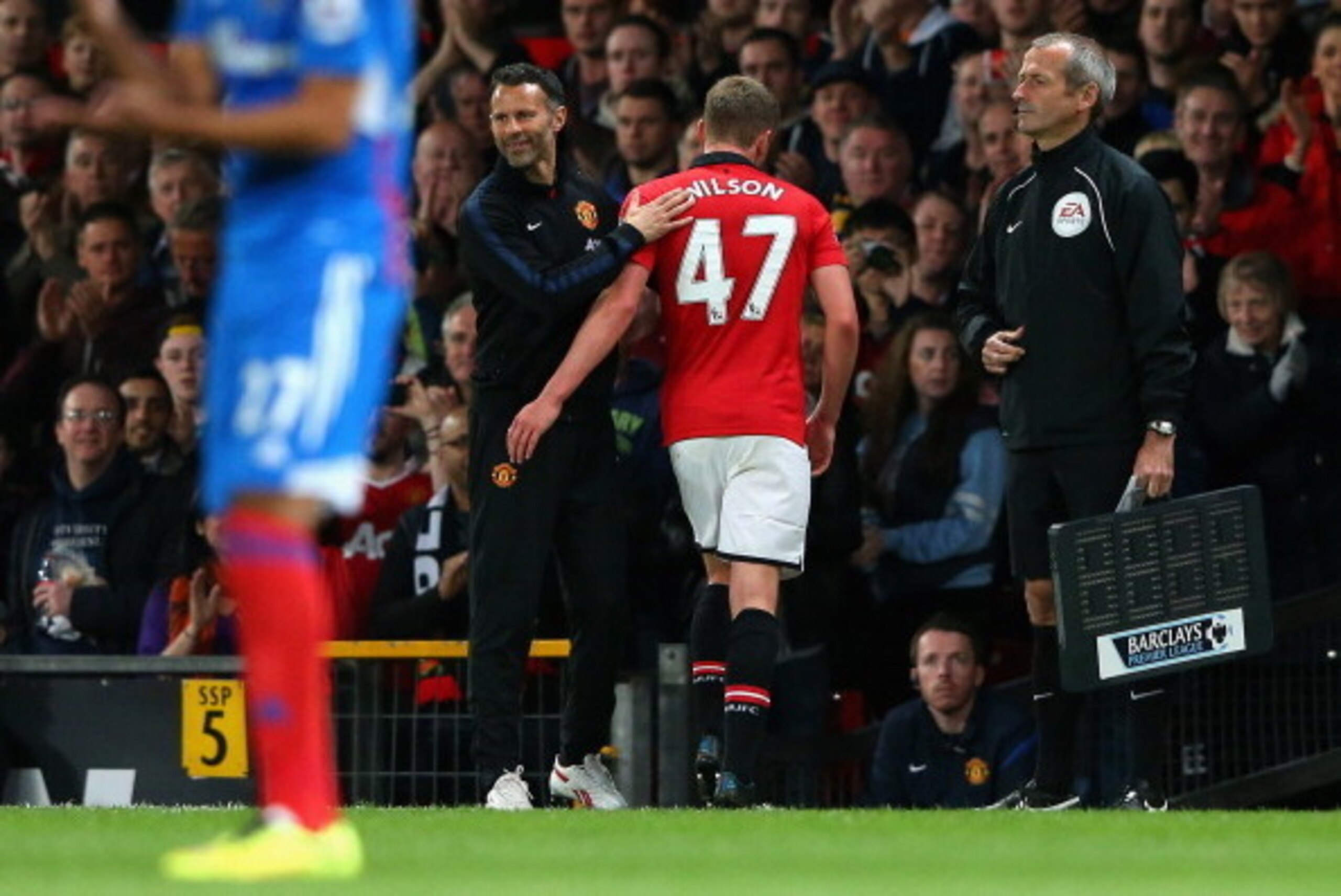 MANCHESTER, ENGLAND - MAY 06:  Manchester United Caretaker Manager Ryan Giggs congratulates James Wilson as he is substituted during the Barclays Premier League match between Manchester United and Hull City at Old Trafford on May 6, 2014 in Manchester, En