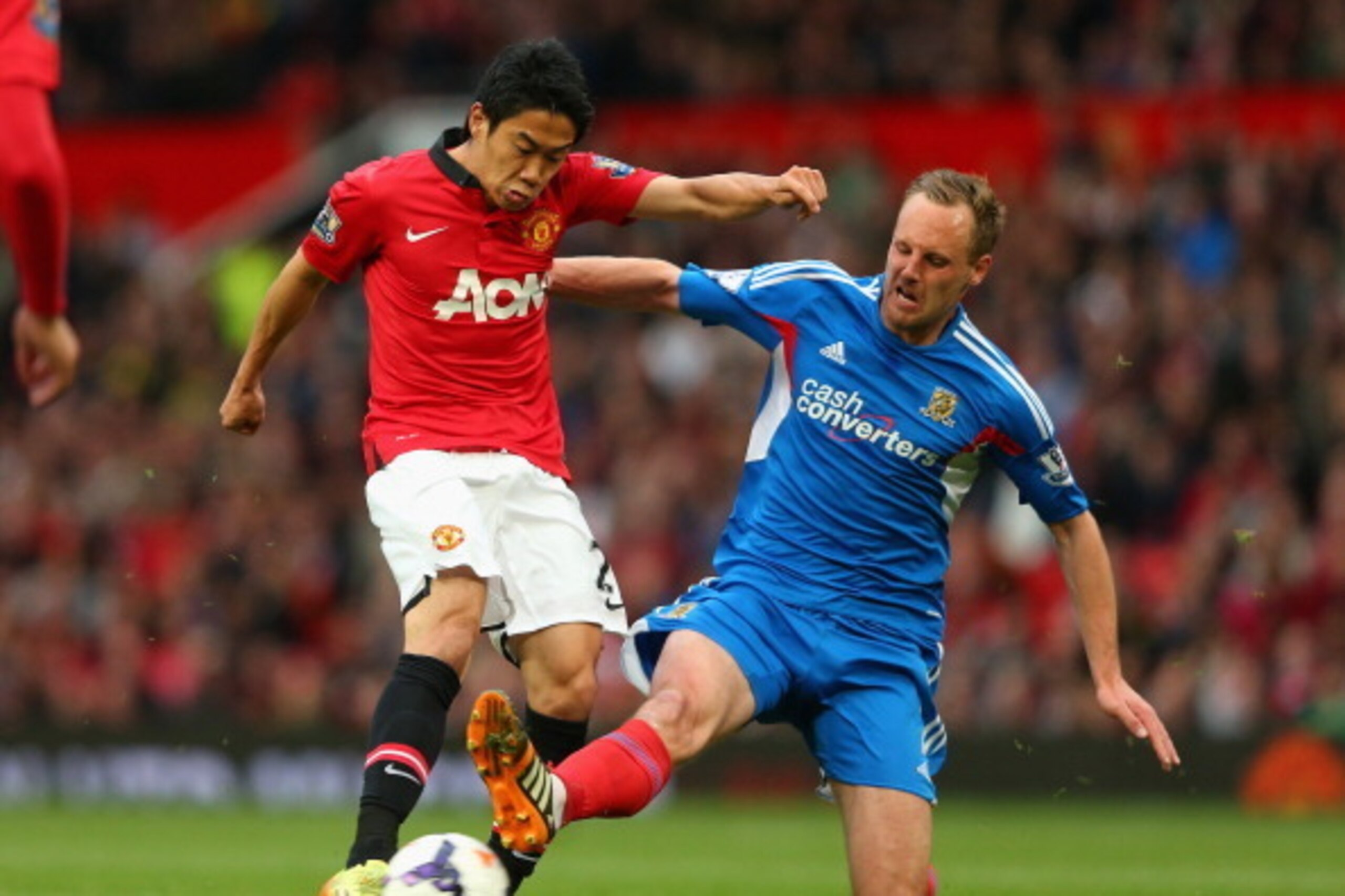 MANCHESTER, ENGLAND - MAY 06:  Shinji Kagawa of Manchester United is challenged by David Meyler of Hull City during the Barclays Premier League match between Manchester United and Hull City at Old Trafford on May 6, 2014 in Manchester, England.  (Photo by