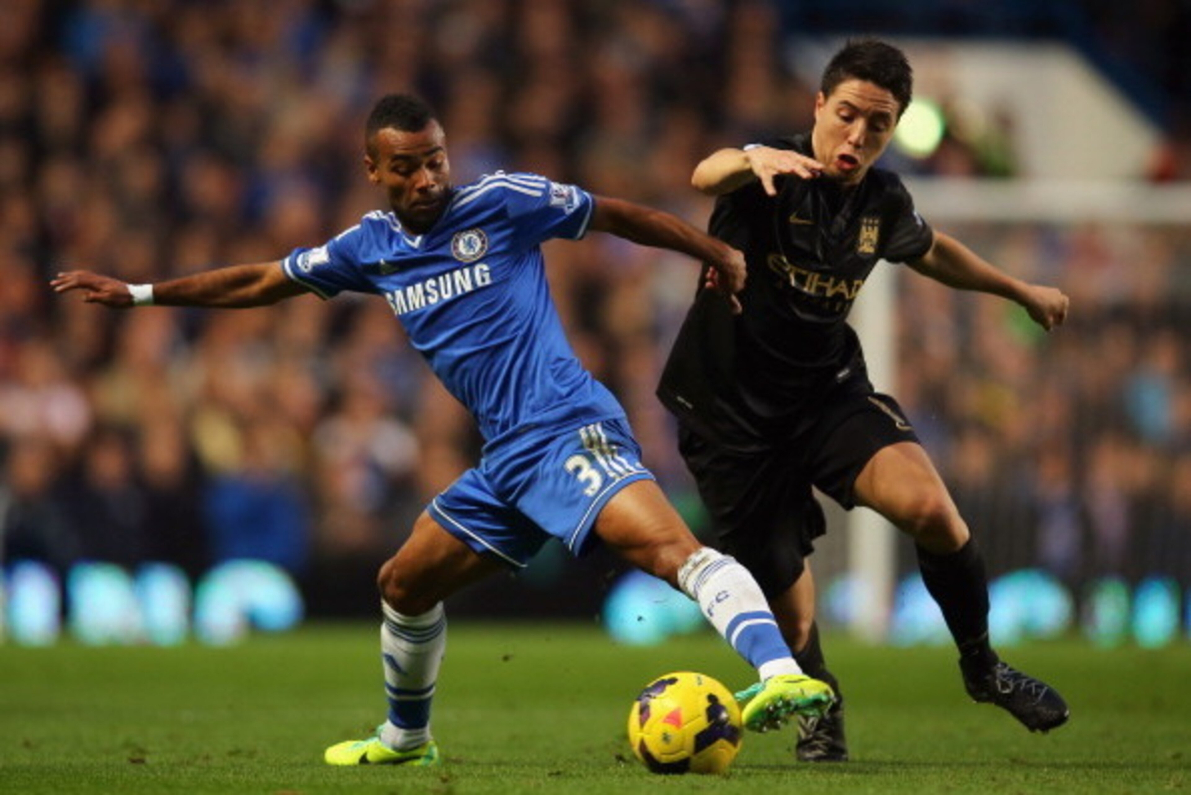 LONDON, ENGLAND - OCTOBER 27:  Ashley Cole of Chelsea and Samir Nasri of Manchester City battle for the ball during the Barclays Premier League match between Chelsea and Manchester City at Stamford Bridge on October 27, 2013 in London, England.  (Photo by