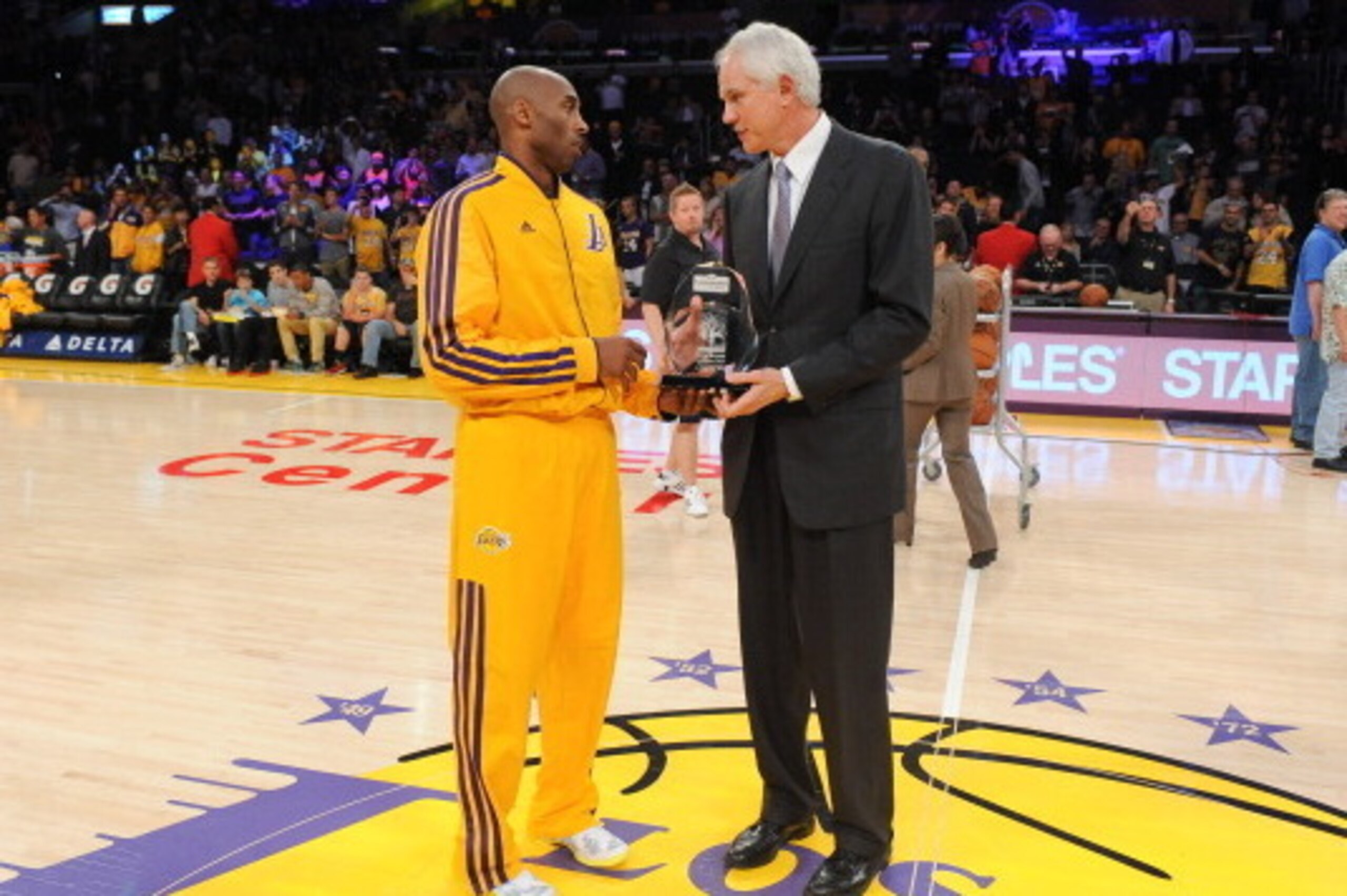 LOS ANGELES, CA - MARCH 22: Kobe Bryant #24 of the Los Angeles Lakers is presented with the Kia Western Conference player of the month award for February 2013 by general manager Mitch Kupchak before their team's game against the Washington Wizards at Stap